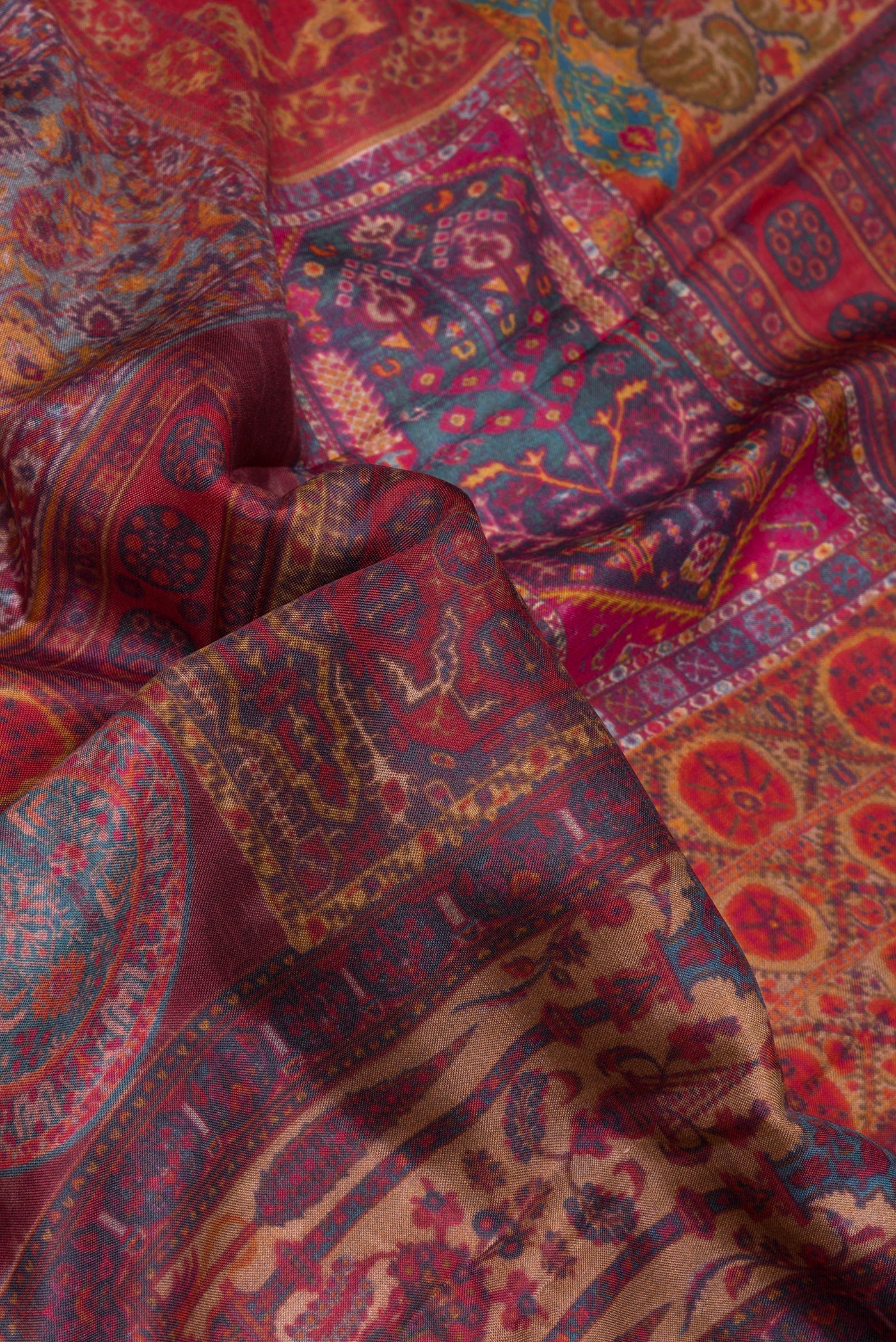 Close up of Maroon Dual Tone Kanchipuram Silk Saree with Printed design on the body and Zari Border.  displaying folds