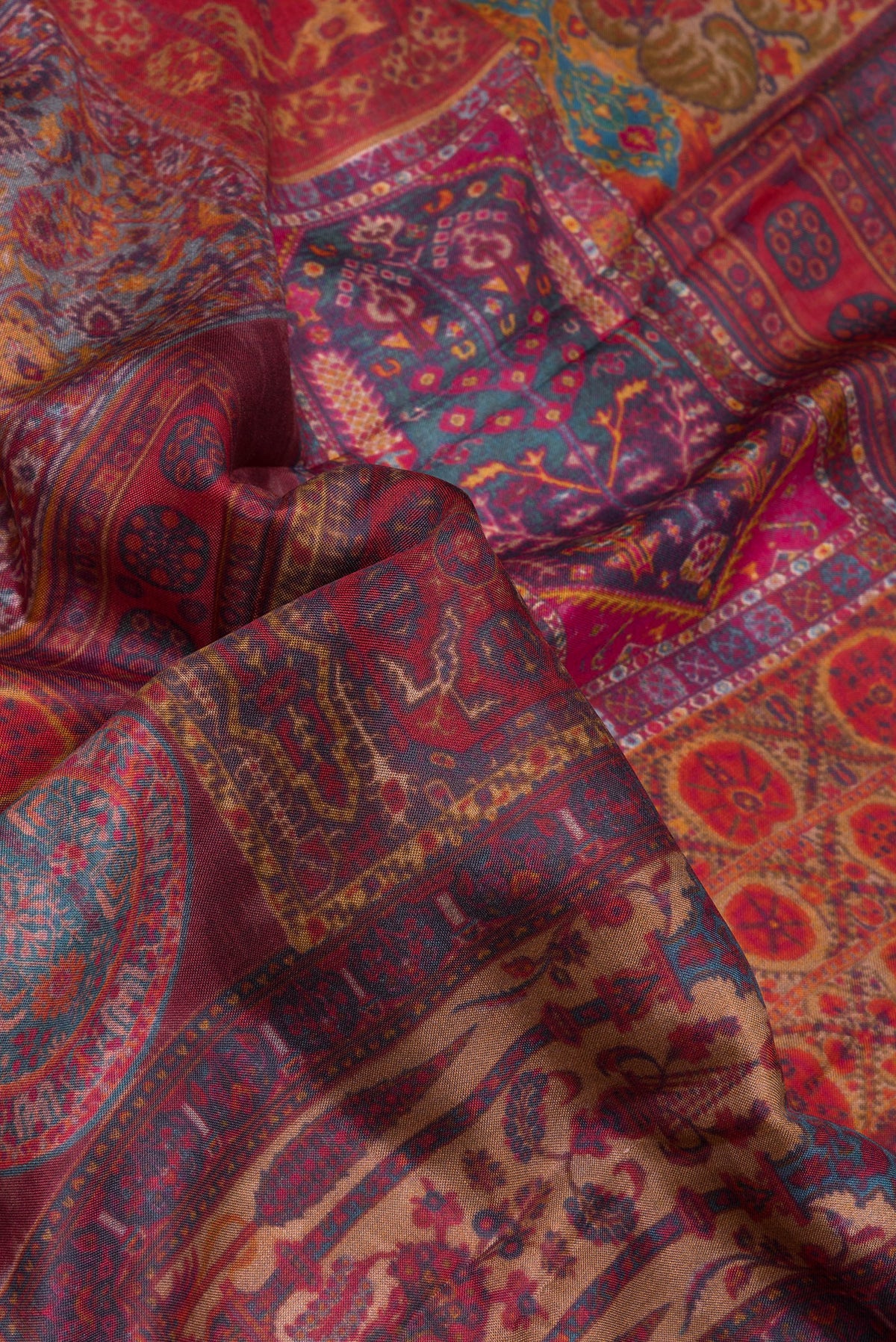 Close up of Maroon Dual Tone Kanchipuram Silk Saree with Printed design on the body and Zari Border.  displaying folds