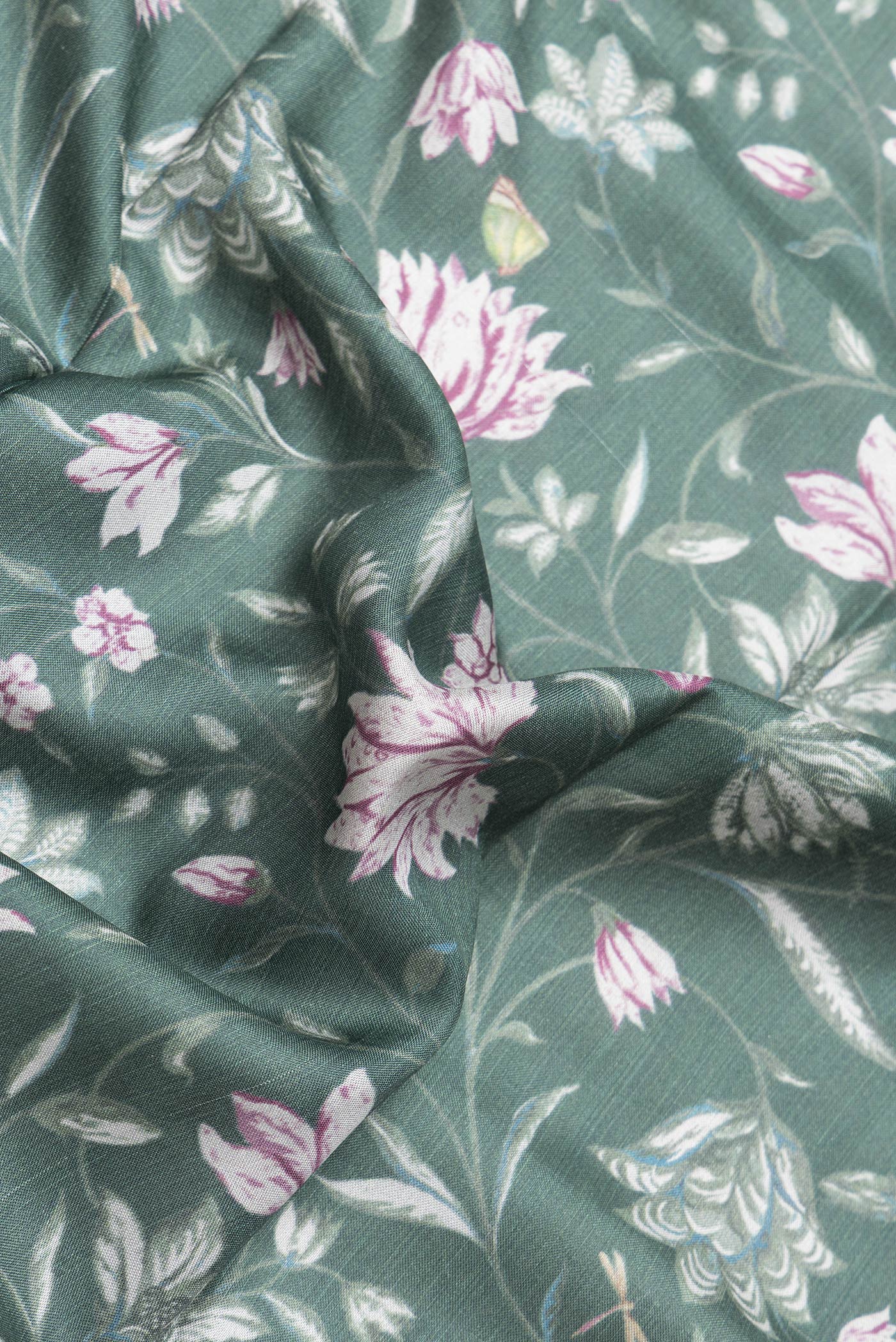 Close up of Green Dual Tone Tussar Silk Saree with Printed design on the body and Zari Border.  displaying folds