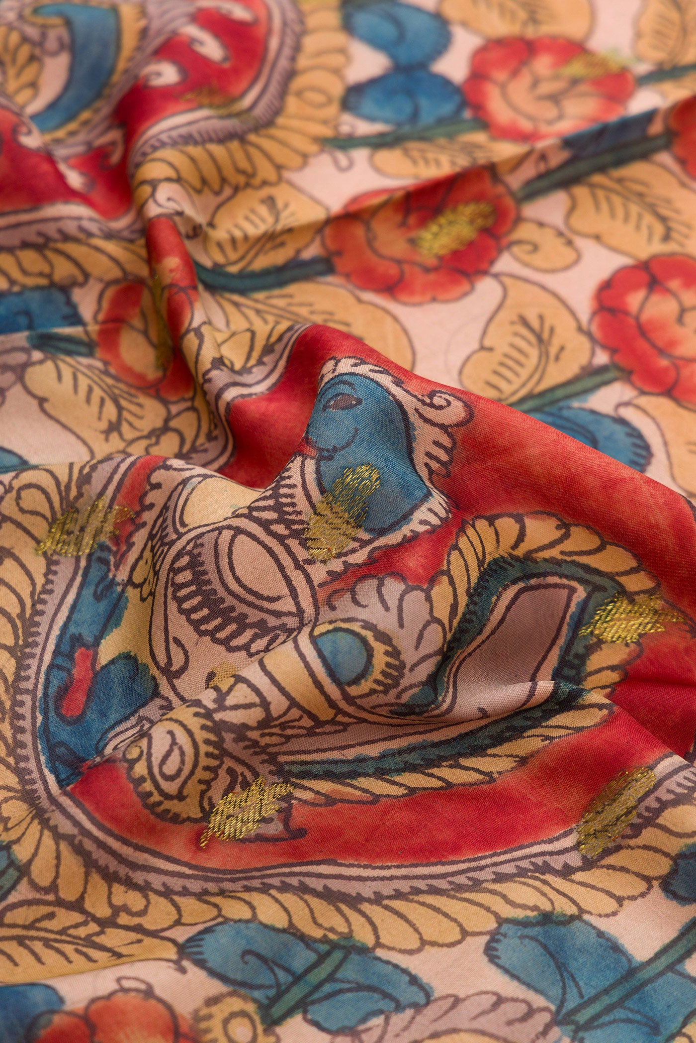 Close up of Golden Peach Dual Tone Kanchipuram Silk Saree with kalamkari Print on the body and Zari Border.  displaying folds