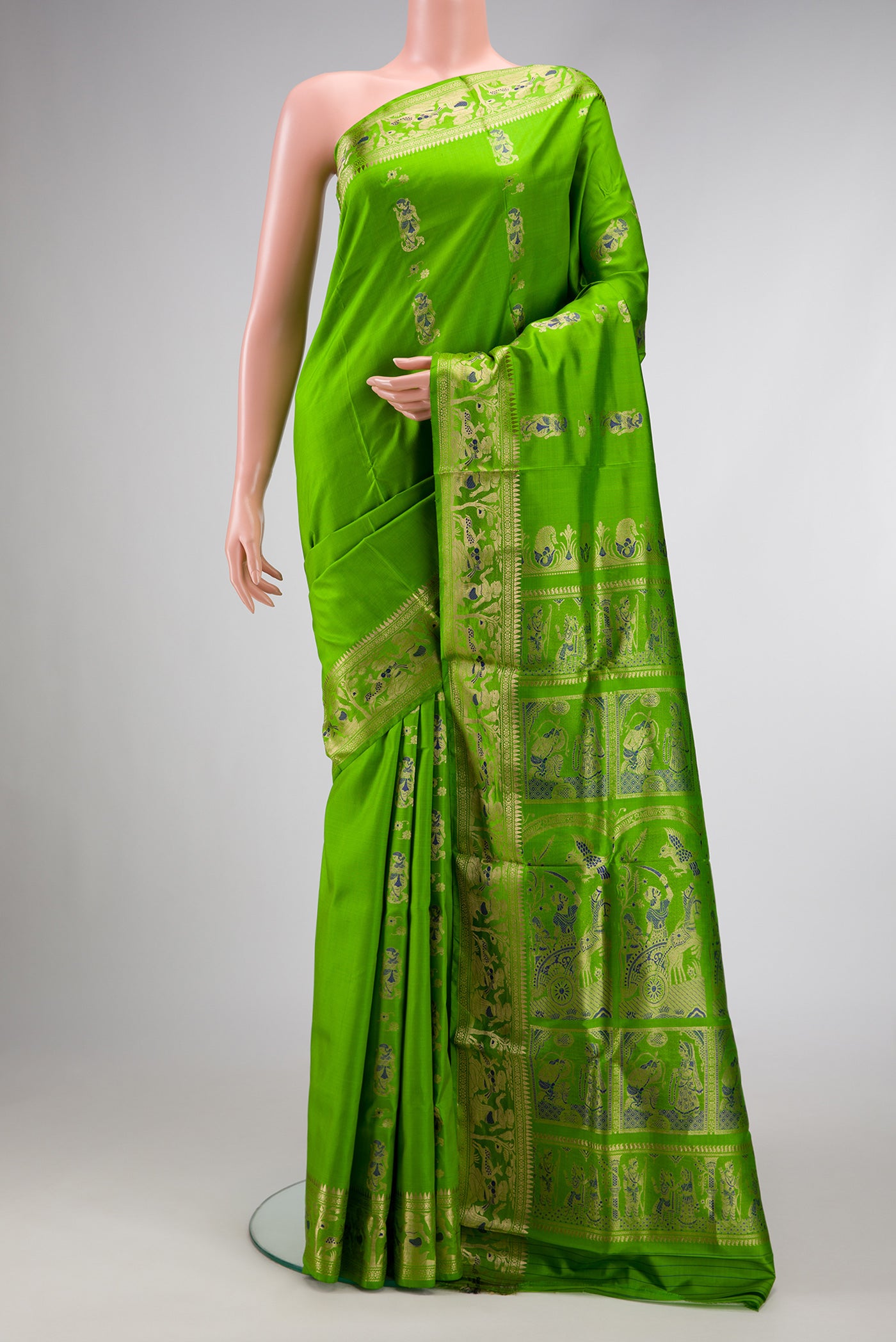 Parrot Green Dual Tone Baluchari Silk Saree with Zari And Thread Butta on the body and Zari Border.  displayed on a mannequin