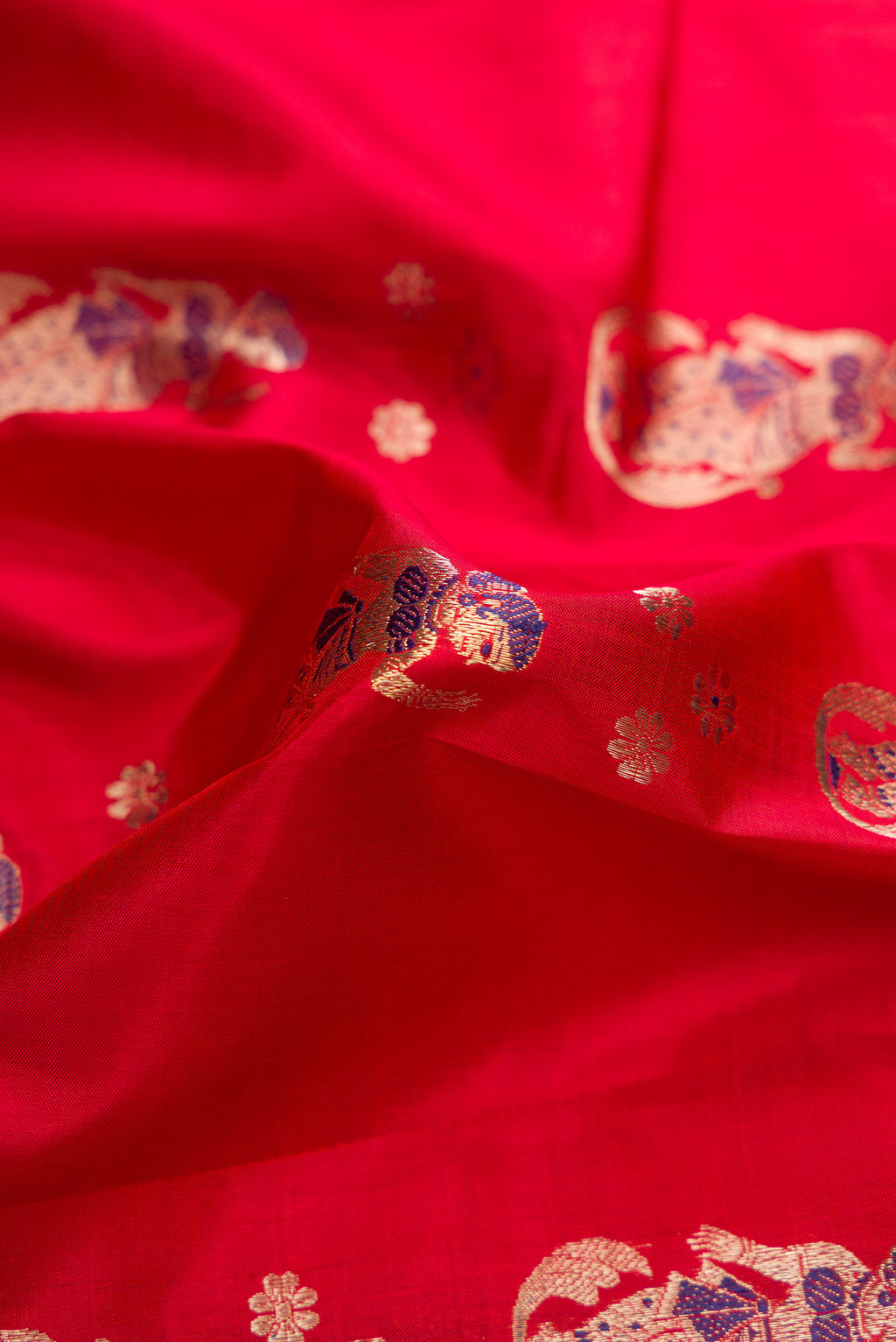 Close up of Dark Mauve Dual Tone Baluchari Silk Saree with Zari And Thread Butta on the body and Fancy Border.  displaying folds
