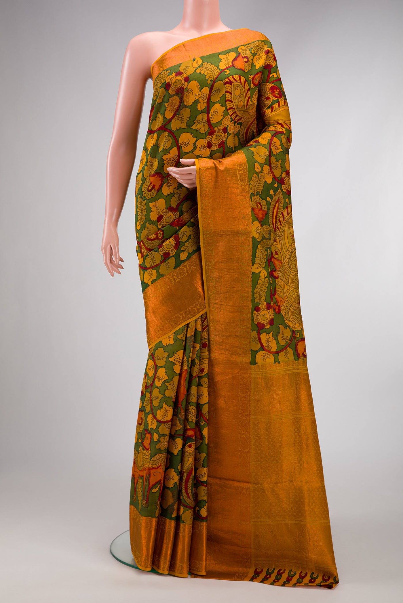 Green Dual Tone Kanchipuram Silk Saree with kalamkari Print on the body and Zari Border.  displayed on a mannequin