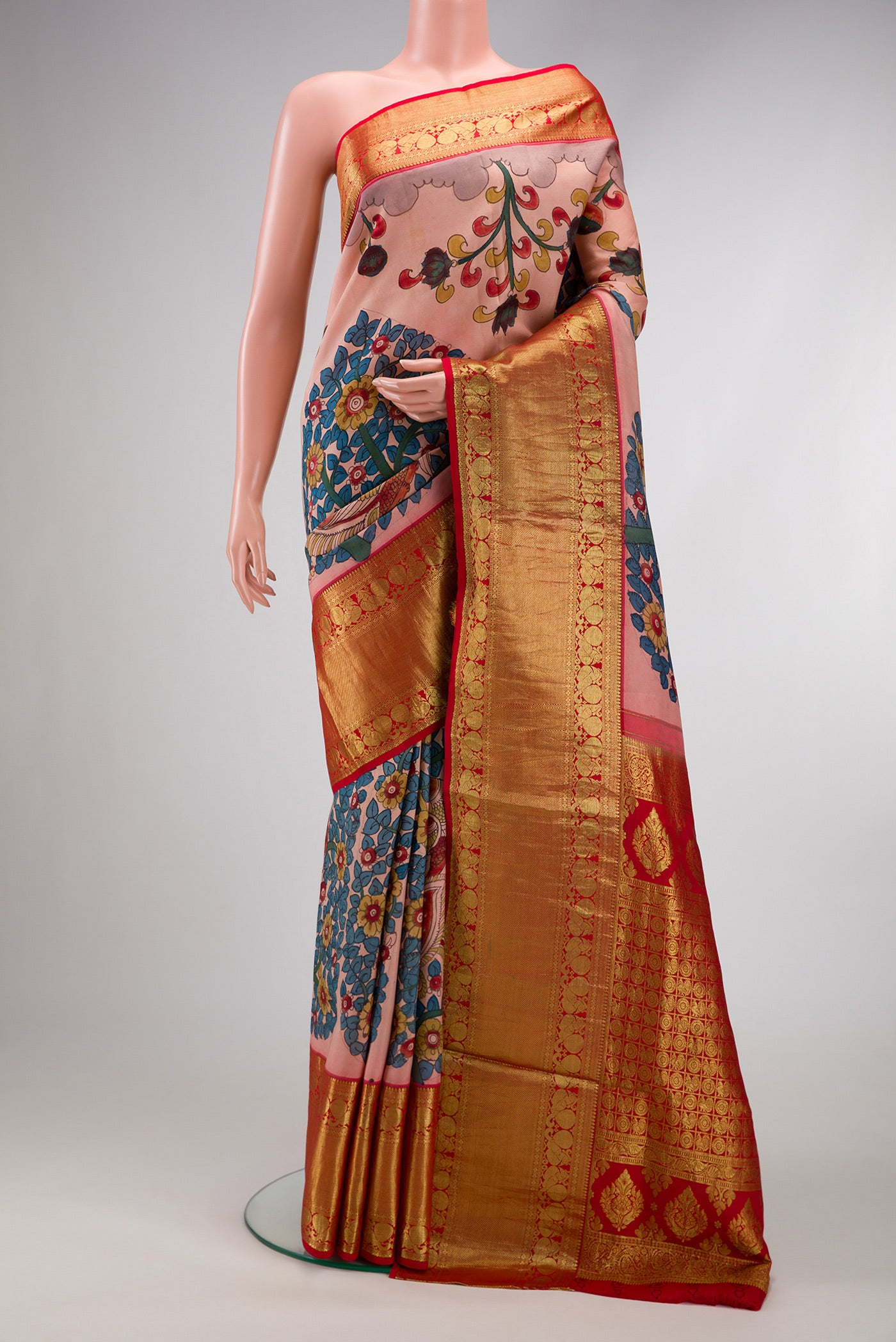 Golden Peach Dual Tone Kanchipuram Silk Saree with kalamkari Print on the body and Zari Border.  displayed on a mannequin