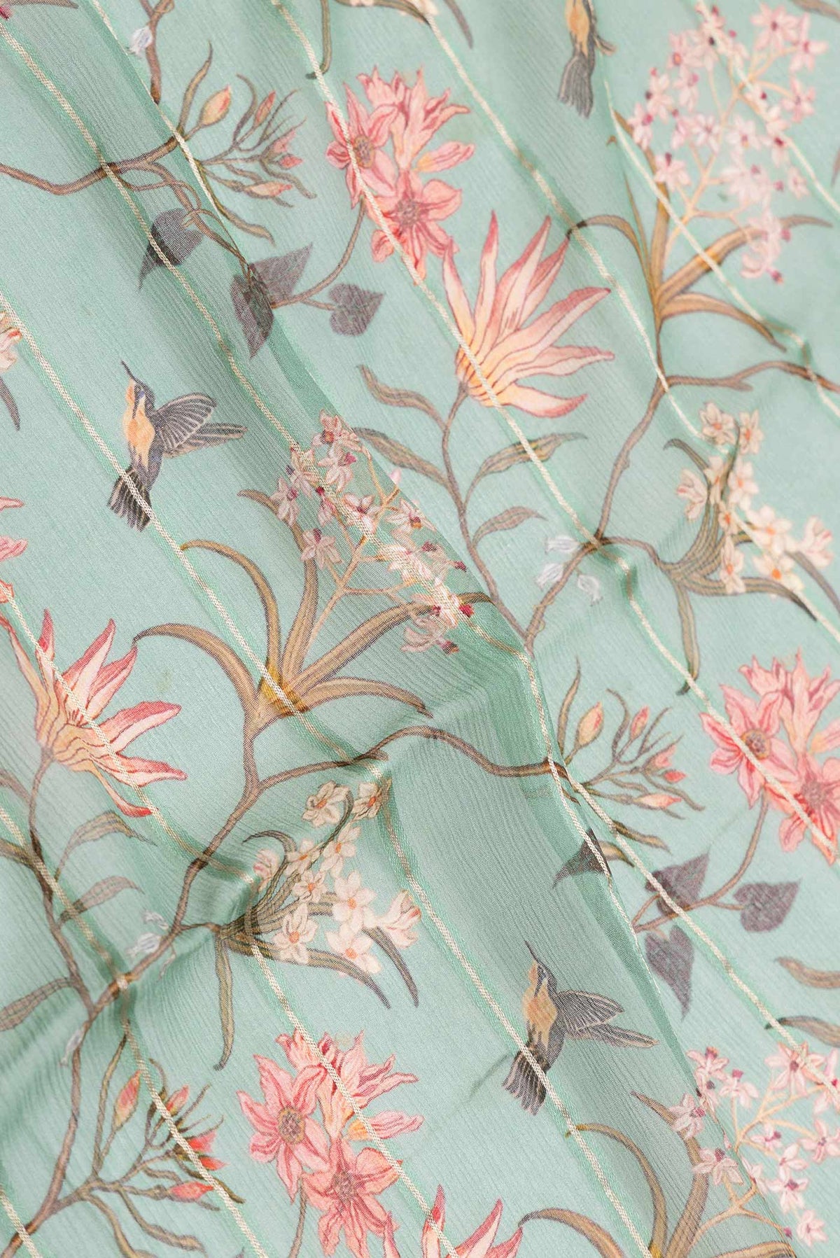 Close up of Green Dual Tone Mysore Chiffon Saree with Printed design on the body and Zari Border displaying folds