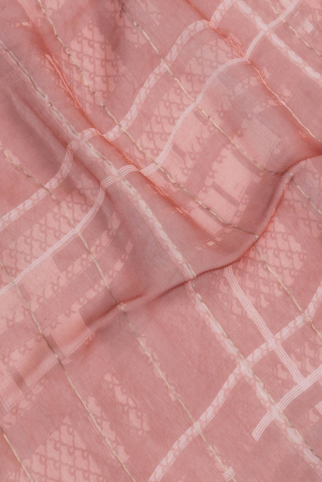 Close up of Bronze Dual Tone Mysore Georgette Saree with Printed design on the body and Zari Border.  displaying folds