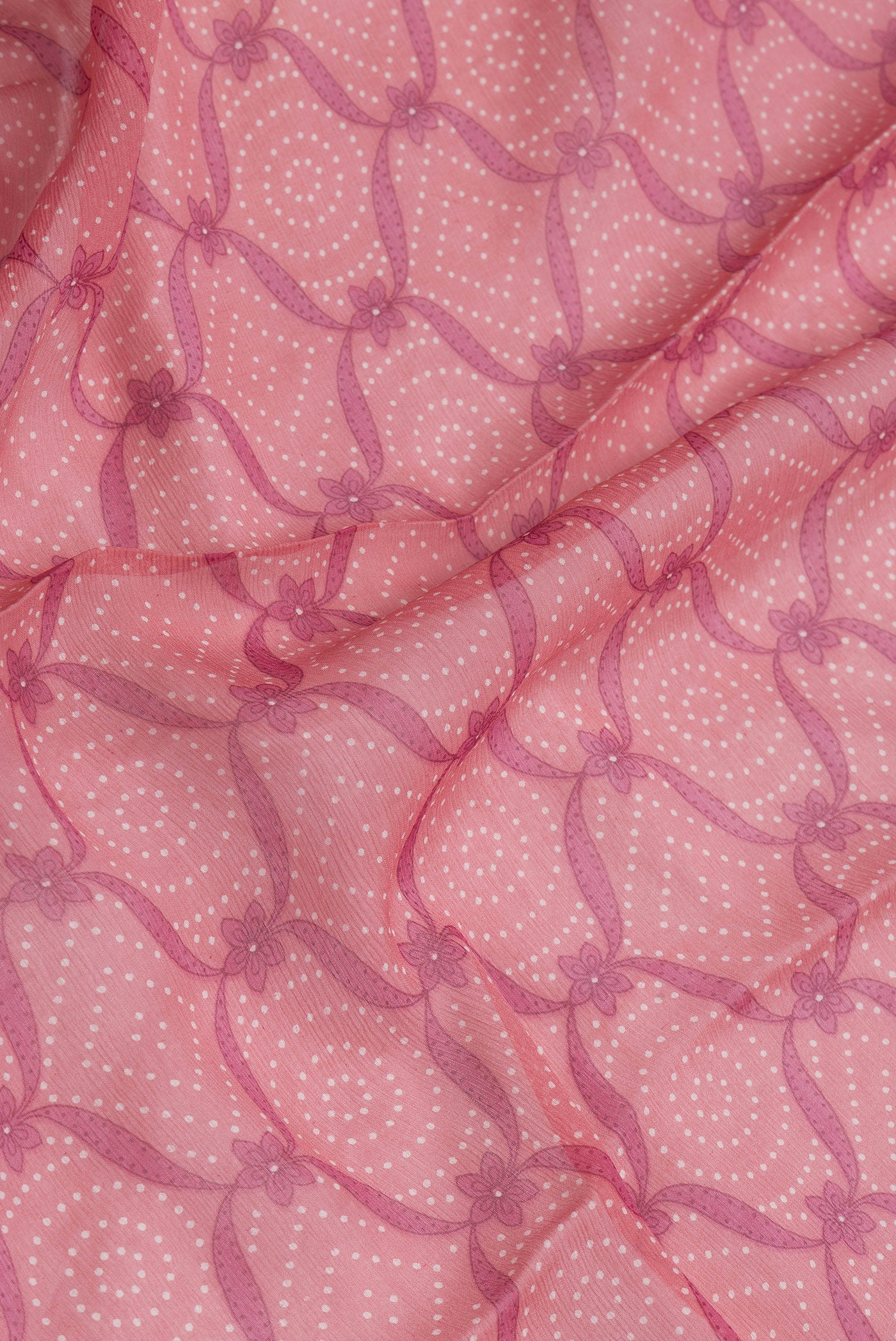 Close up of Pink Dual Tone Mysore Chiffon Saree with Printed design on the body and Printed Border.  displaying folds