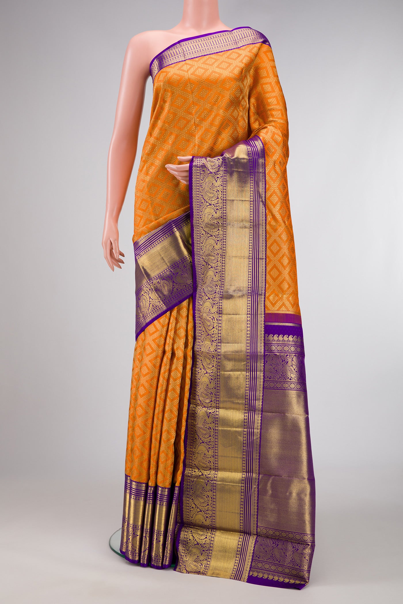 Pure Silk Pure Zari Orange Dual Tone Kanjivaram Saree with Zari Brocade on the body and Zari Border.  displayed on a mannequin