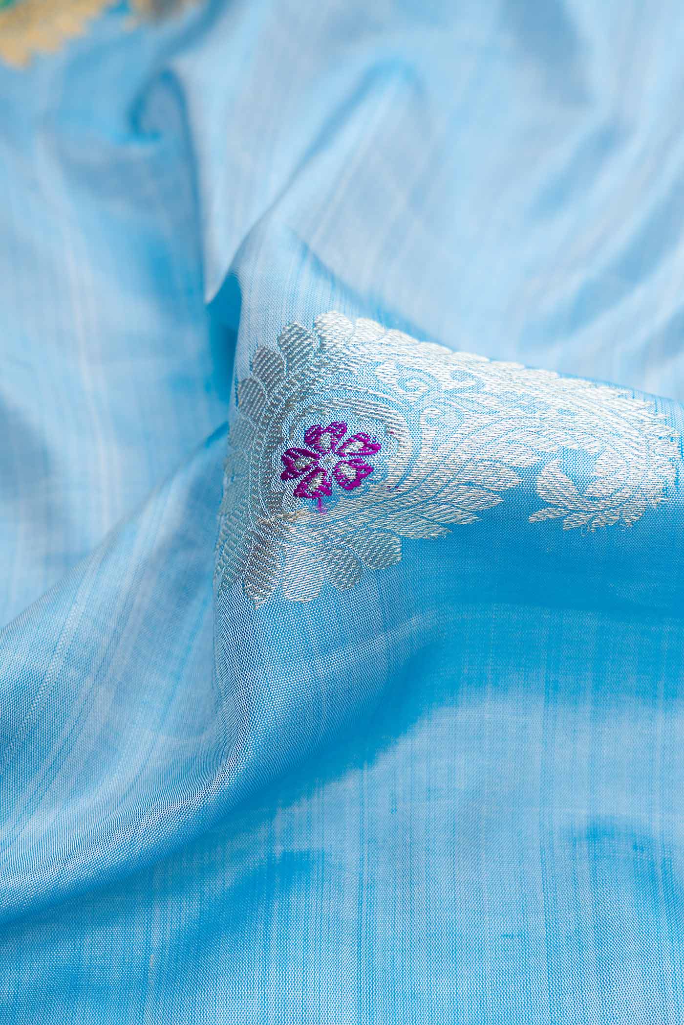 Close up of Light Blue Dual Tone Gadwal Silk Saree with Zari Butta on the body and Zari Border displaying folds