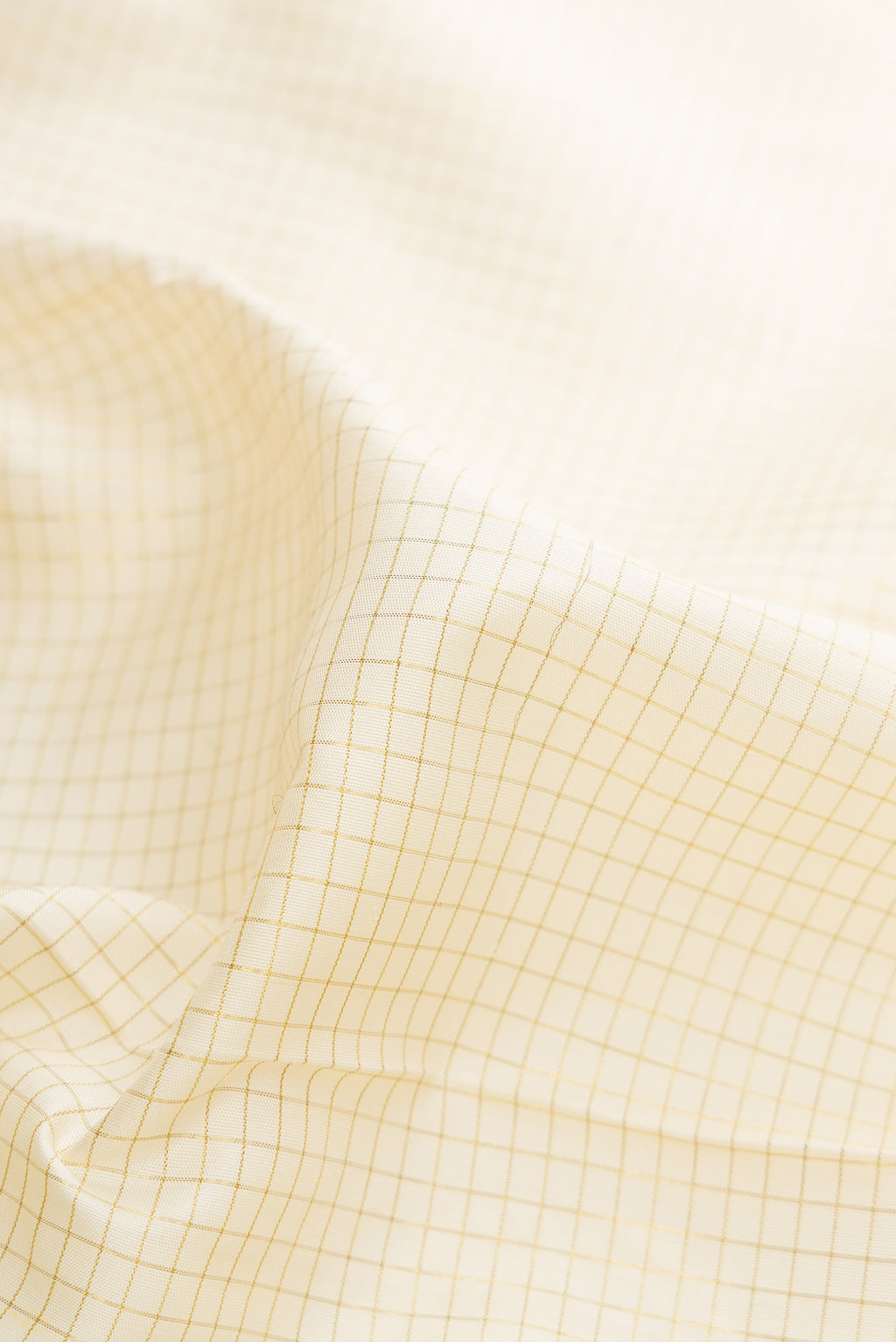 Close up of Pure Silk Off White Kanjivaram Saree with Checked design on the body and Zari Border.  displaying folds