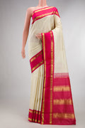 Pure Silk Off White Kanjivaram Saree with Checked design on the body and Zari Border.  displayed on a mannequin