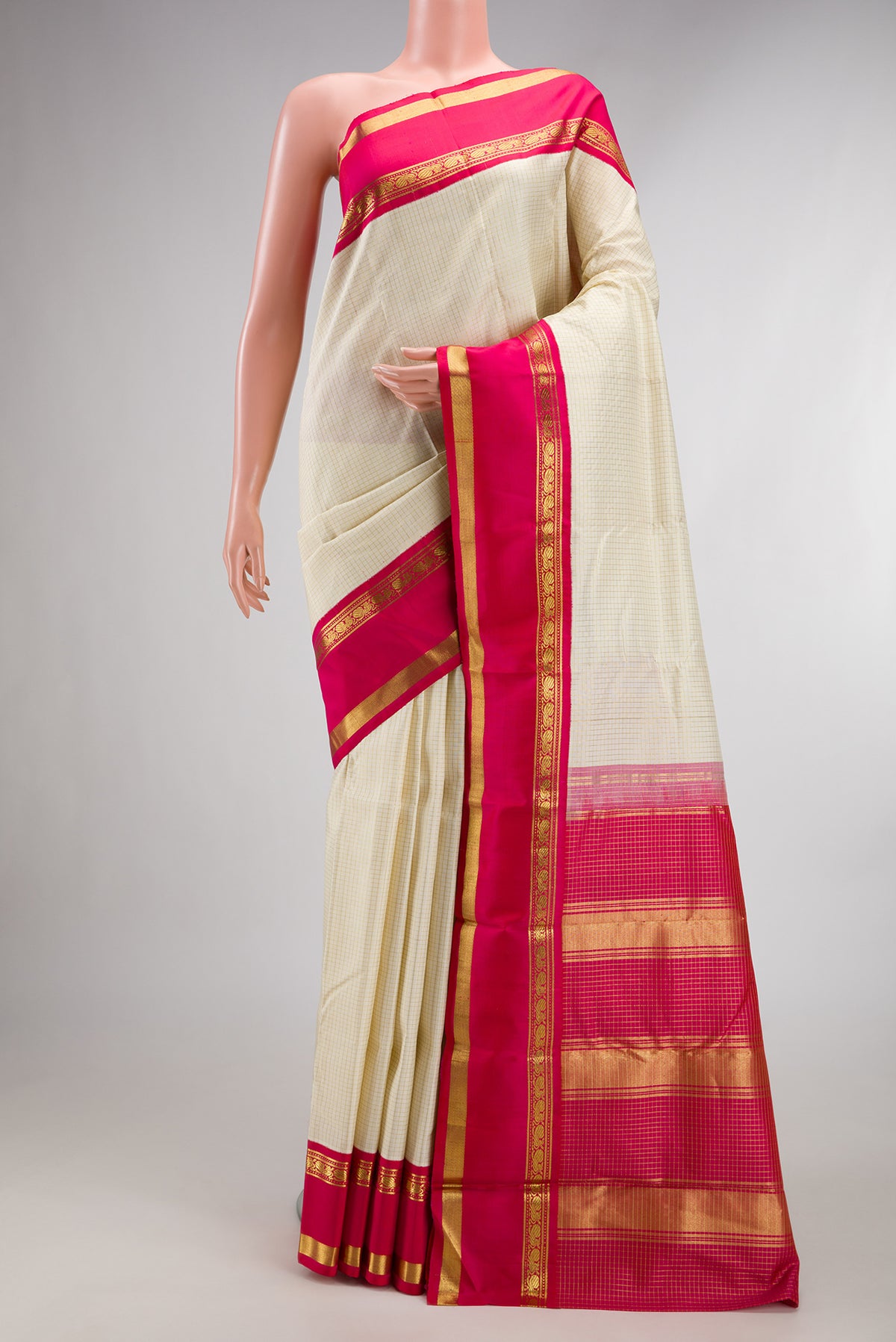 Pure Silk Off White Kanjivaram Saree with Checked design on the body and Zari Border.  displayed on a mannequin