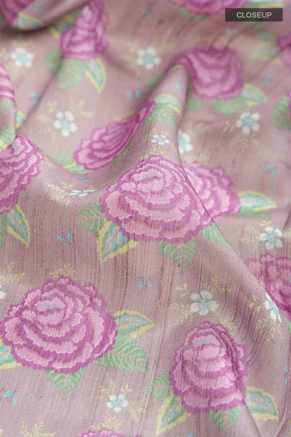 Close up of Lavender Bhagalpuri Tussar Silk Saree with Printed design on the body and Zari Border displaying folds