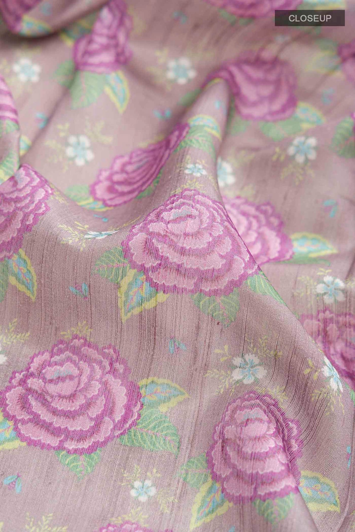Close up of Lavender Bhagalpuri Tussar Silk Saree with Printed design on the body and Zari Border displaying folds