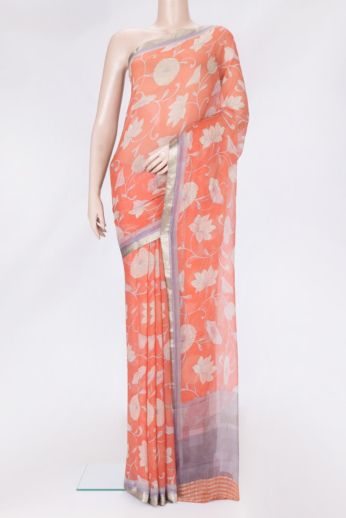 Orange Dual Tone Chiffon Saree with Printed design on the body and Zari Border.  displayed on a mannequin
