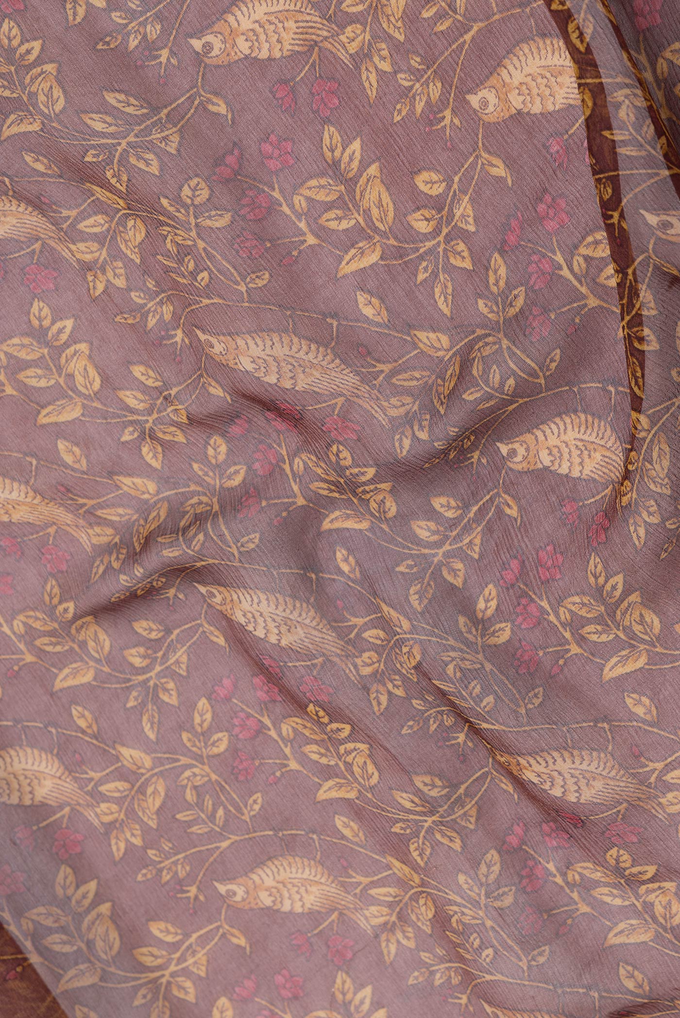 Close up of Brown Dual Tone Mysore Chiffon Saree with Printed design on the body and Zari Border.  displaying folds