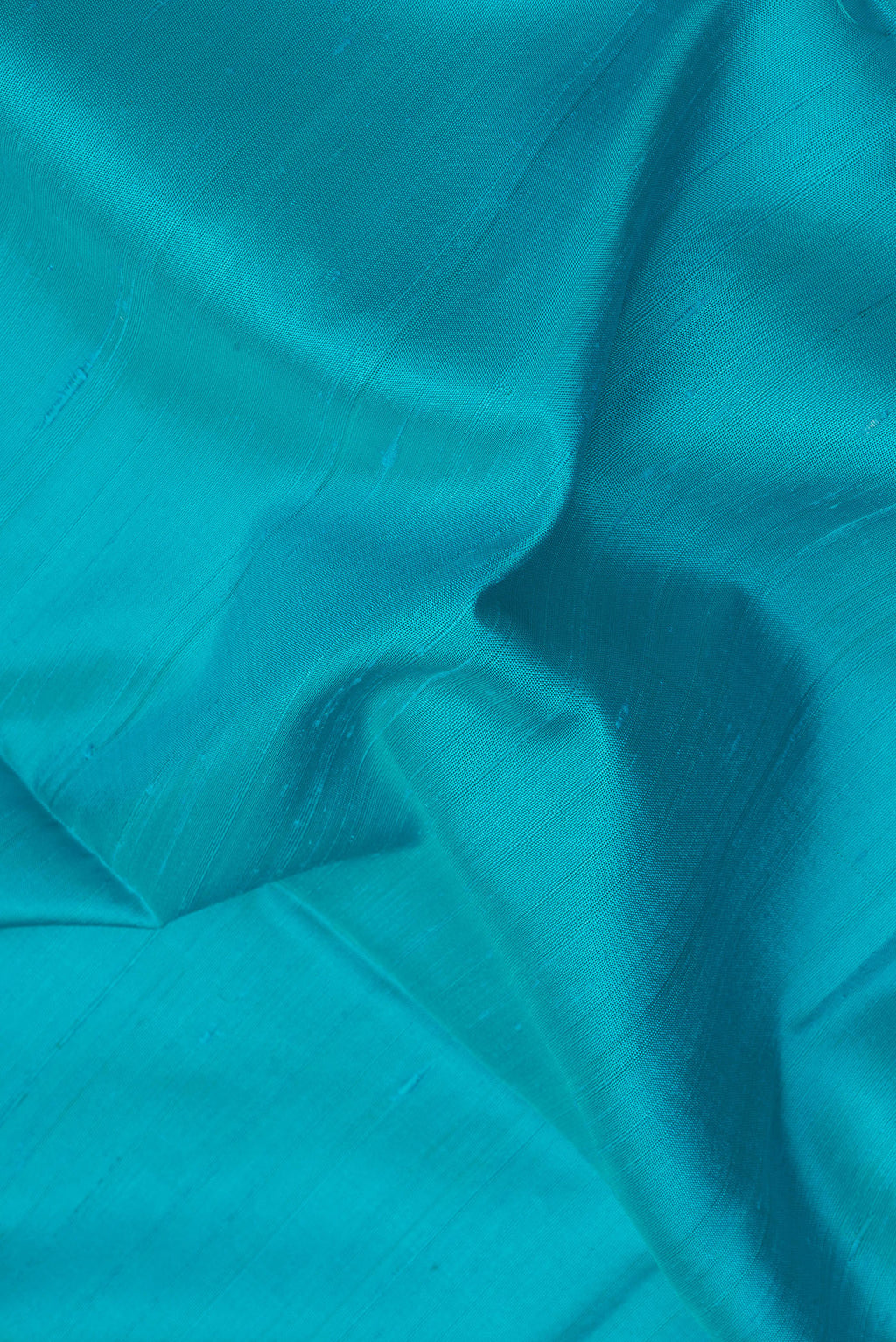 Close up of Sky Blue Soft Silk Saree with Plain Body and Zari Border.  displaying folds