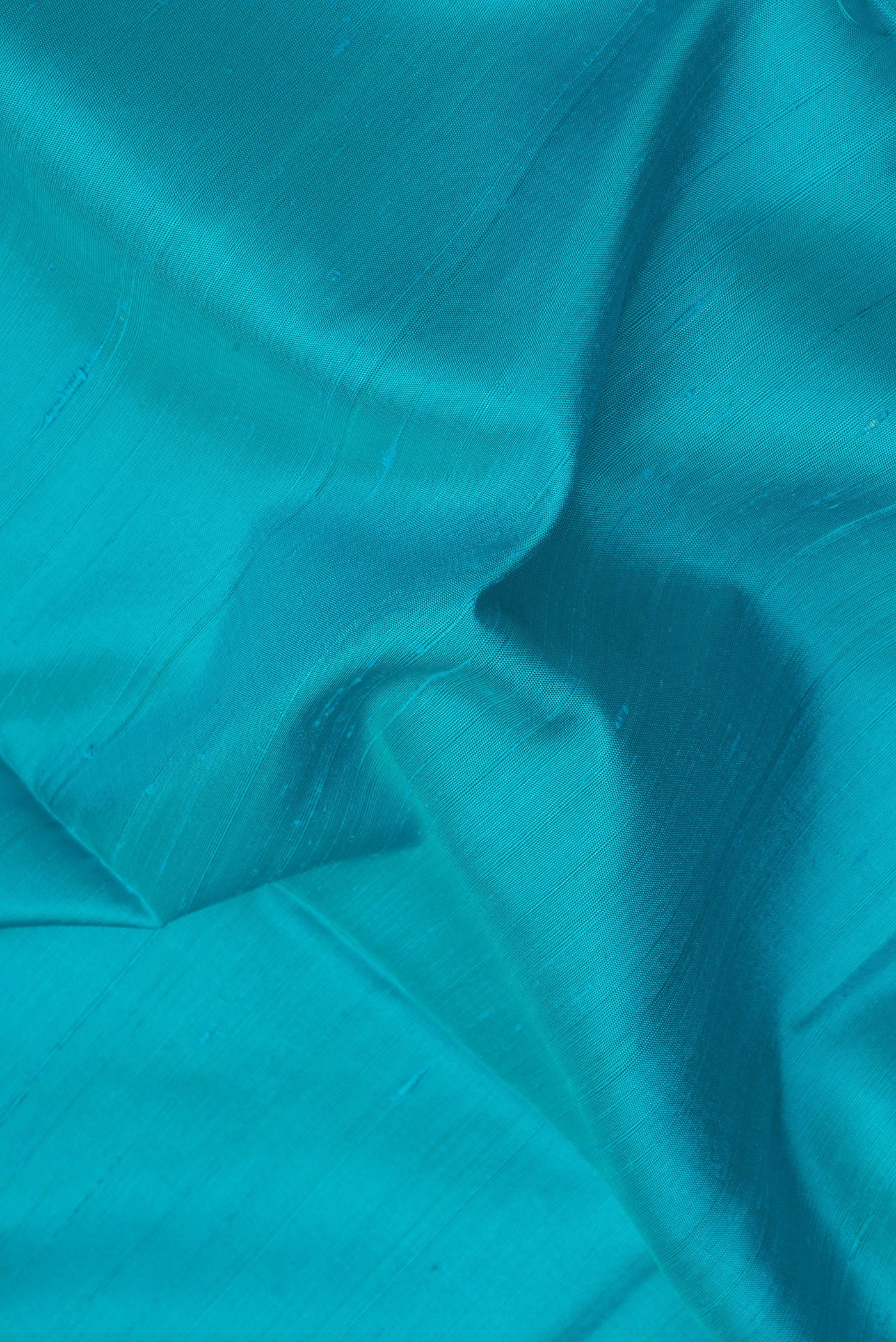 Close up of Sky Blue Soft Silk Saree with Plain Body and Zari Border.  displaying folds