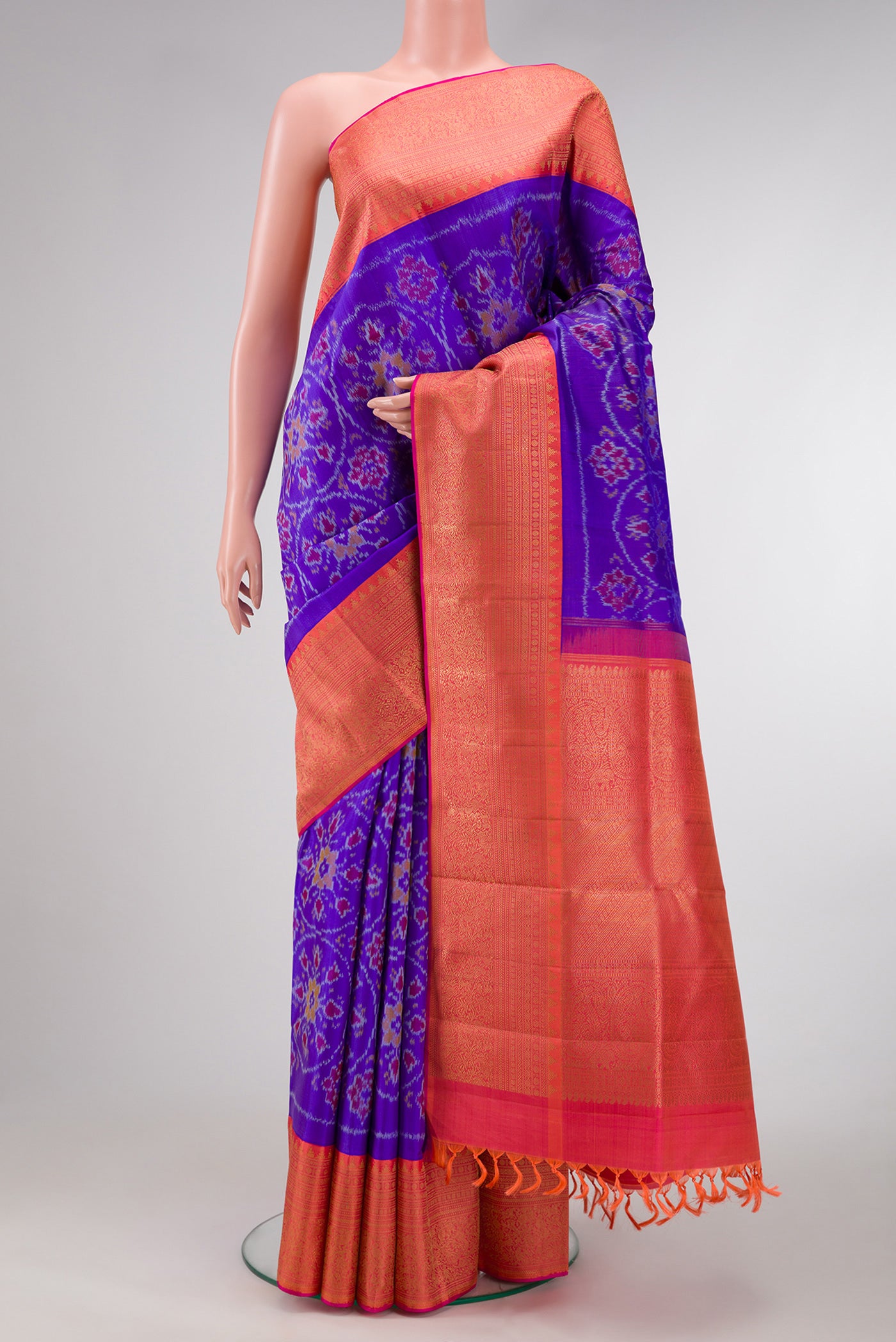 Orange Dual Tone Double Ikat Saree with Ikat Print on the body and Ikat Border.  displayed on a mannequin