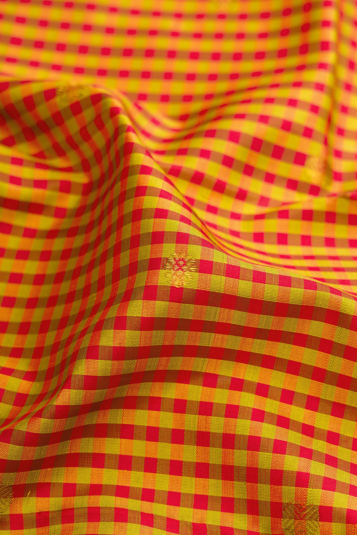 Close up of Pure Silk Pure Zari Multi Color Kanjivaram Saree with Checked design on the body and Fancy Border.  displaying folds