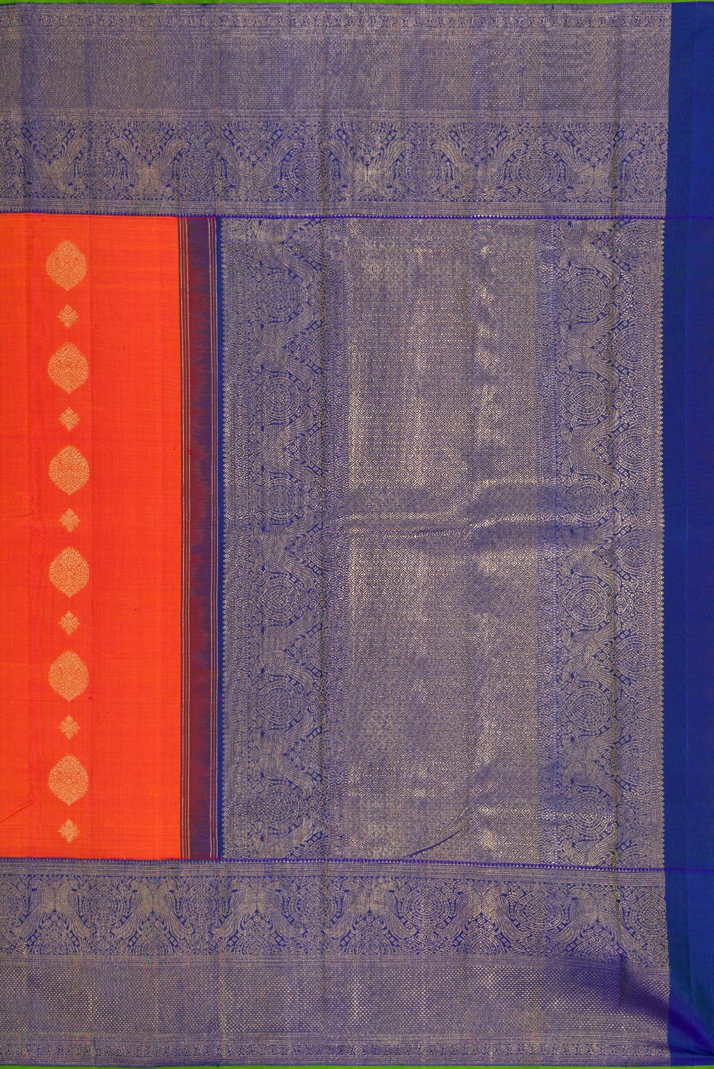 Close up image of the pallu of Pure Silk Pure Zari Orange Kanjivaram Saree with Zari Butta on the body and Fancy Border. 