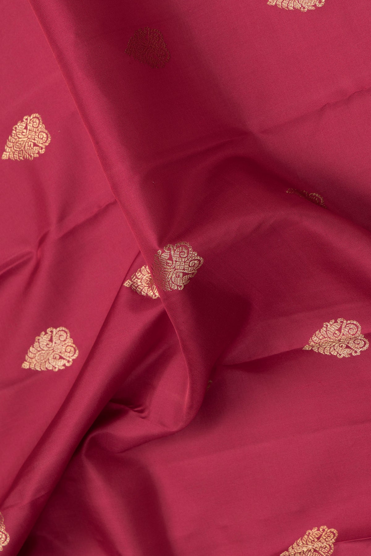 Close up of Maroon Dual Tone Kanjivaram Silk Saree with Zari Butta on the body and Zari Border.  displaying folds