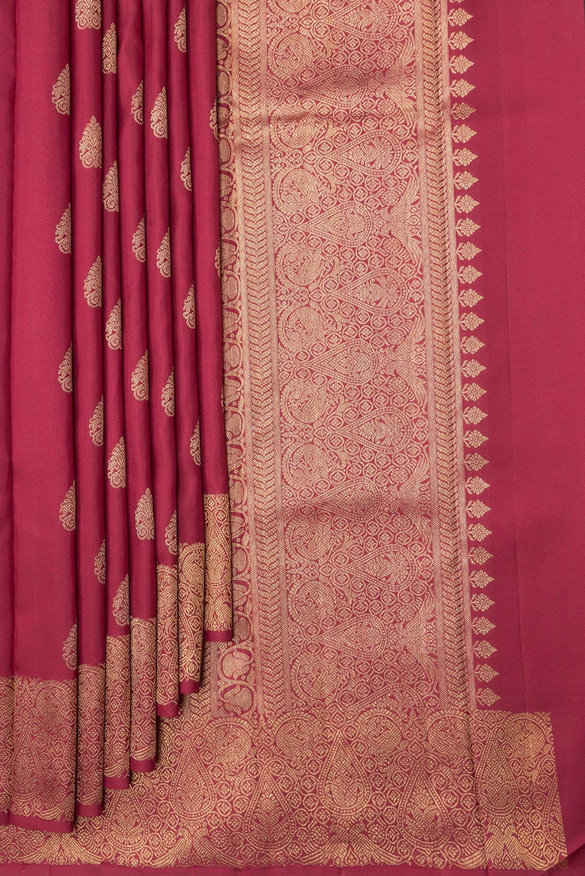 Pleats and pallu of Maroon Dual Tone Kanjivaram Silk Saree with Zari Butta on the body and Zari Border. 