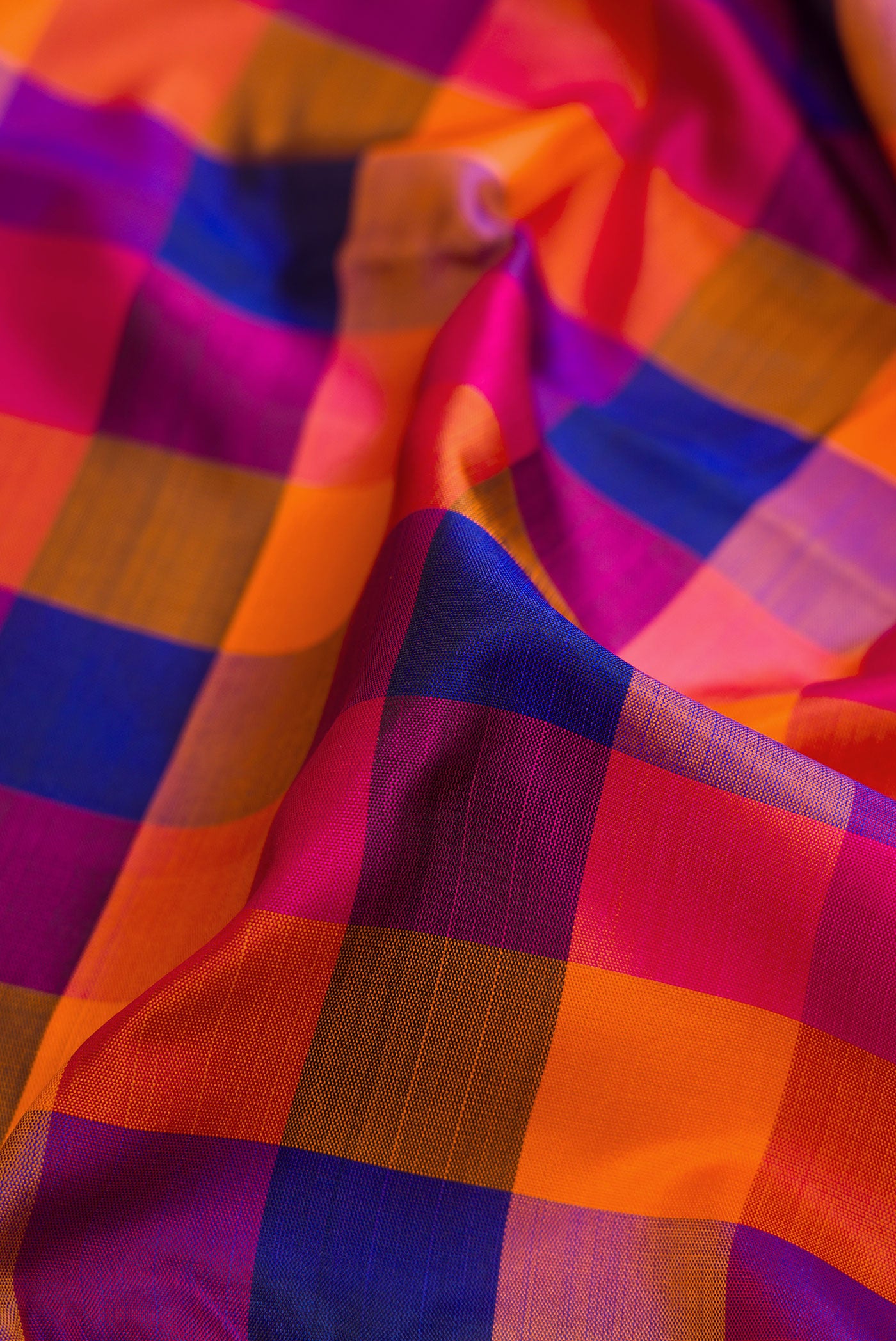Close up of Multi Color Kanchipuram Silk Saree with Checked design on the body and Thin Zari Line.  displaying folds