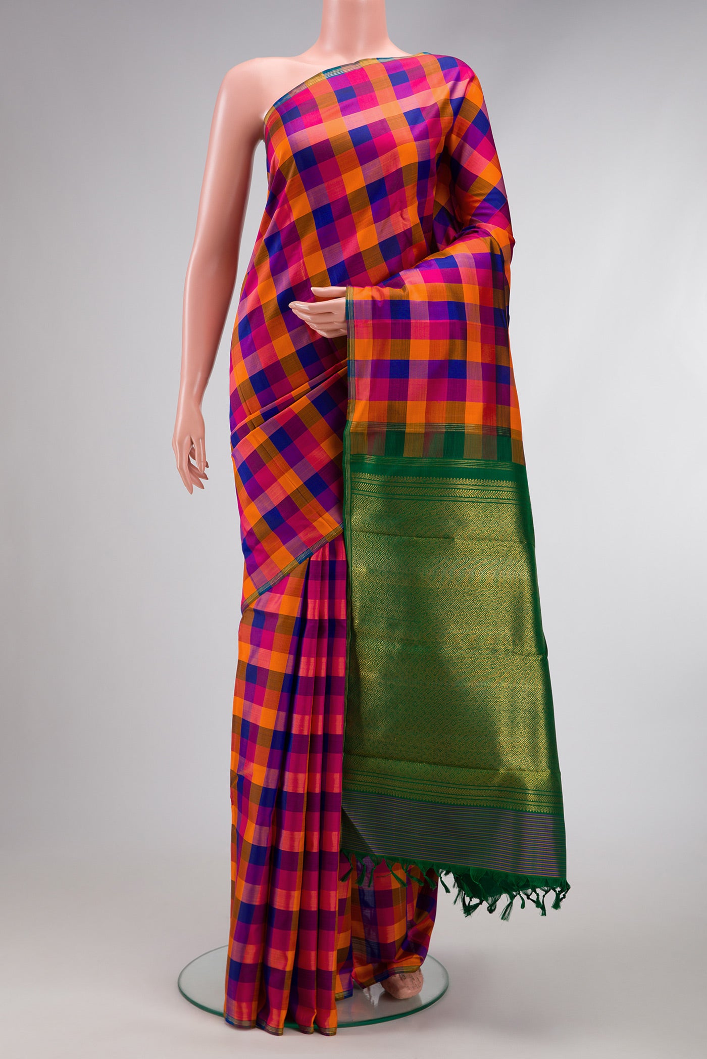 Multi Color Kanchipuram Silk Saree with Checked design on the body and Thin Zari Line.  displayed on a mannequin