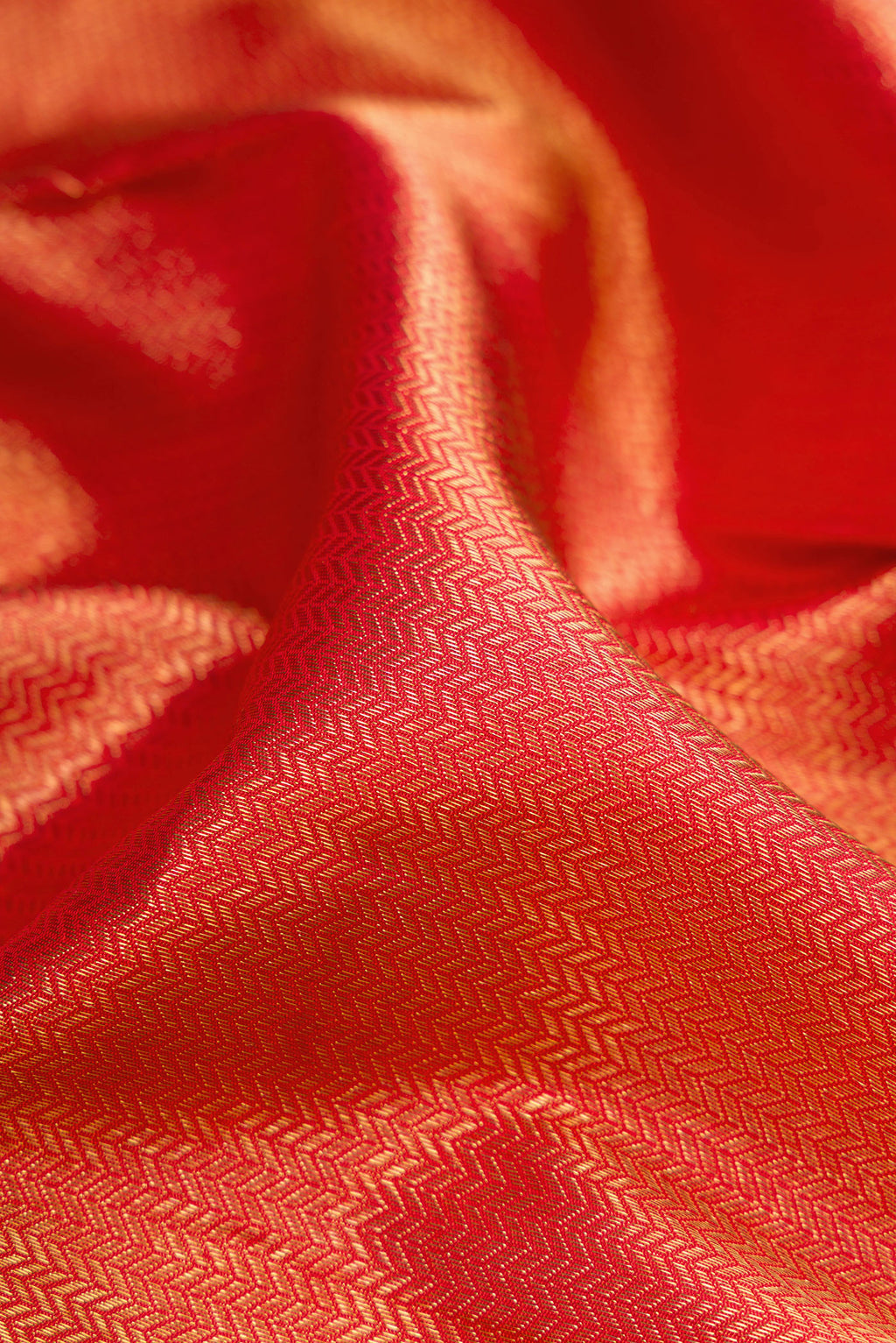 Close up of Pure Silk Pure Zari Red Dual Tone Kanjivaram Saree with Zari Brocade on the body and Zari Border.  displaying folds