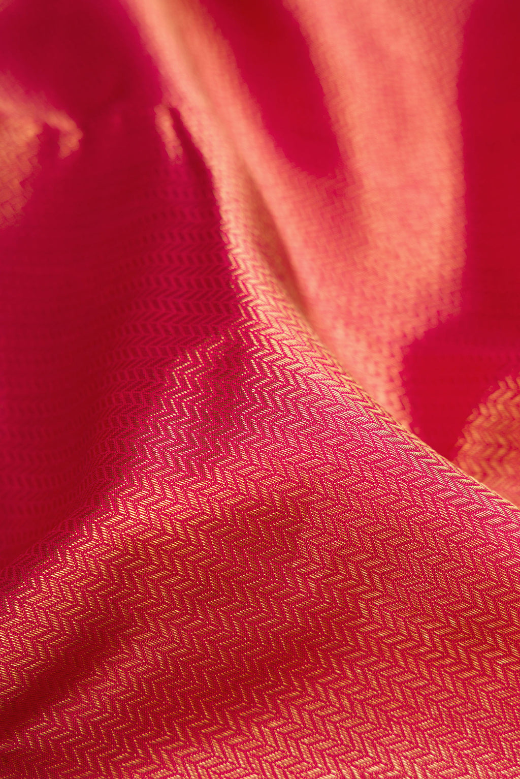 Close up of Pure Silk Pure Zari Maroon Dual Tone Kanjivaram Saree with Zari Brocade on the body and Zari Border.  displaying folds