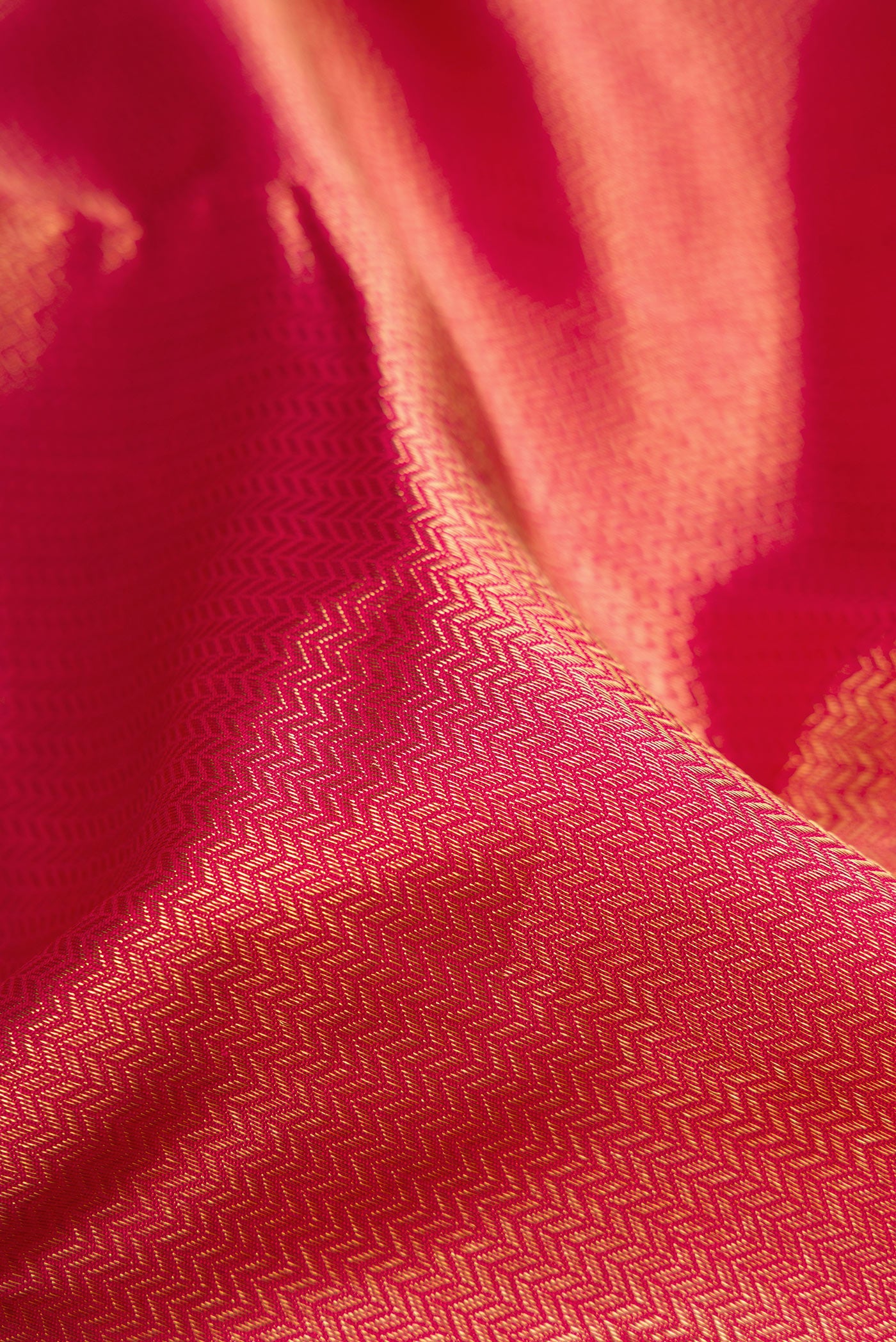 Close up of Pure Silk Pure Zari Maroon Dual Tone Kanjivaram Saree with Zari Brocade on the body and Zari Border.  displaying folds
