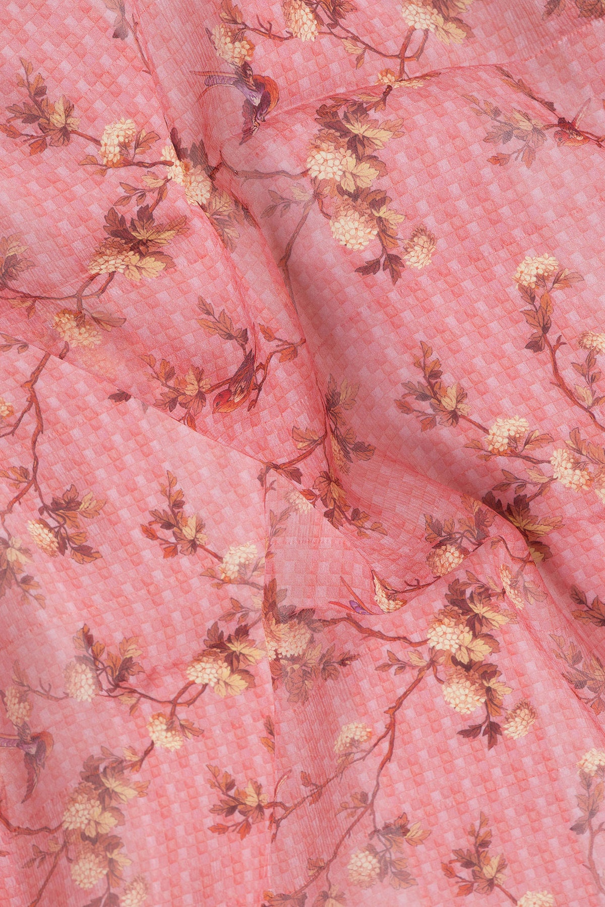 Close up of Golden Peach Dual Tone Mysore Georgette Saree with Printed design on the body and Zari Border.  displaying folds