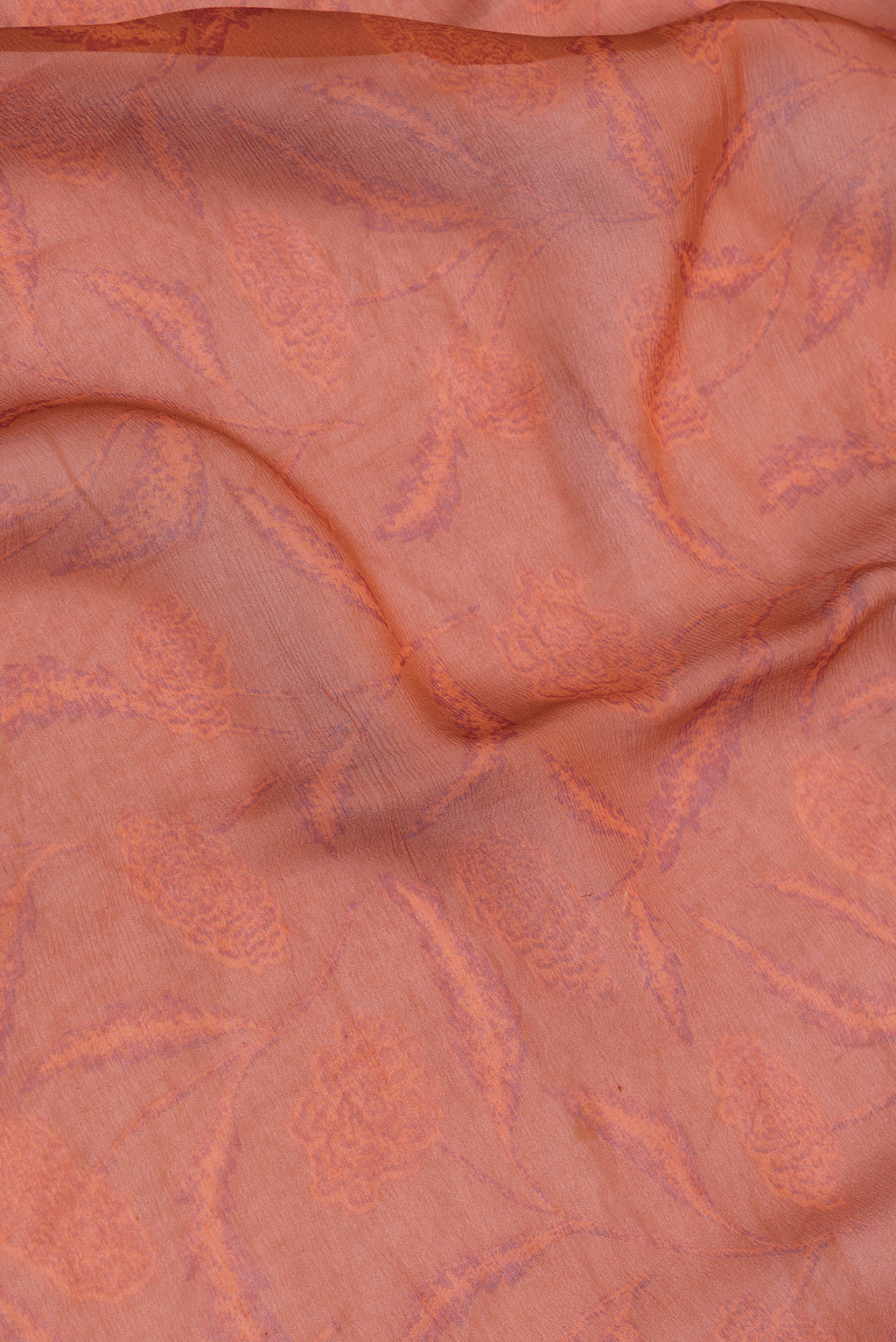 Close up of Orange Dual Tone Mysore Chiffon Saree with Printed design on the body and Plain Border.  displaying folds
