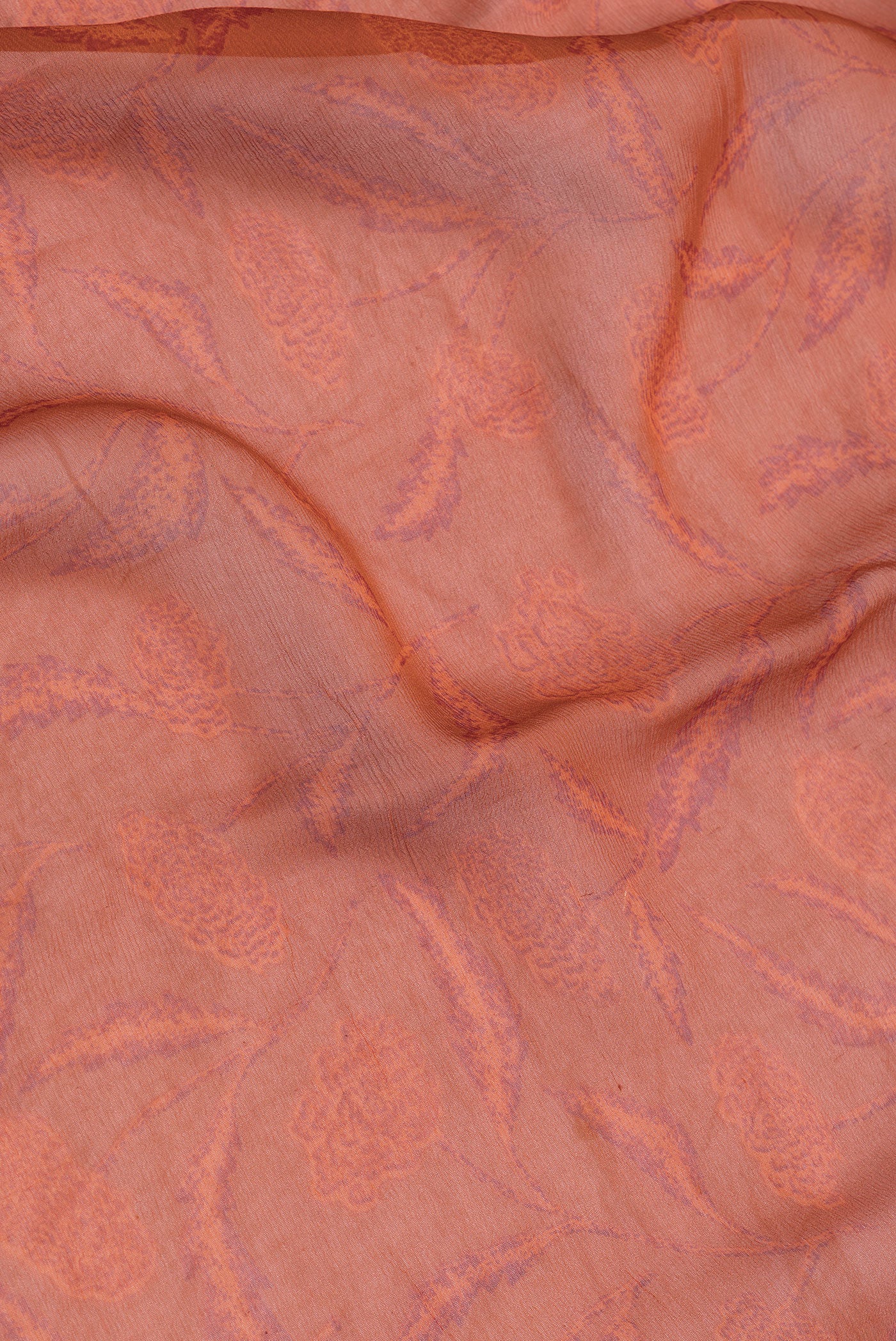 Close up of Orange Dual Tone Mysore Chiffon Saree with Printed design on the body and Plain Border.  displaying folds