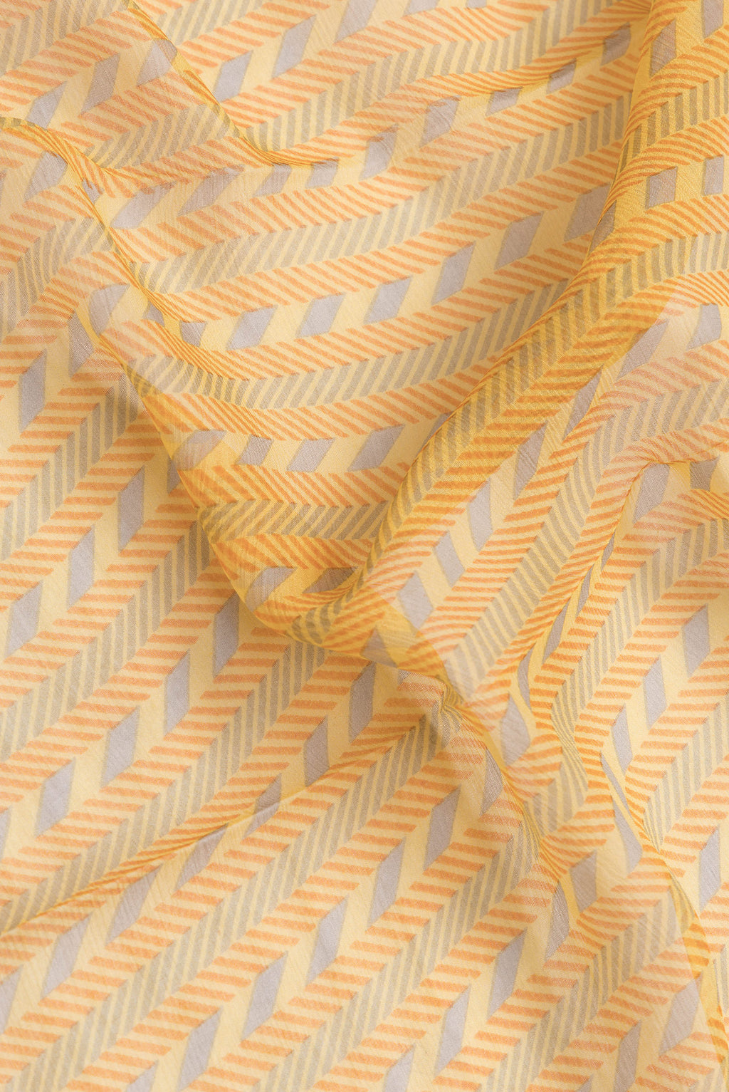 Close up of Yellow Dual Tone Mysore Georgette Saree with Printed design on the body and Zari Border.  displaying folds