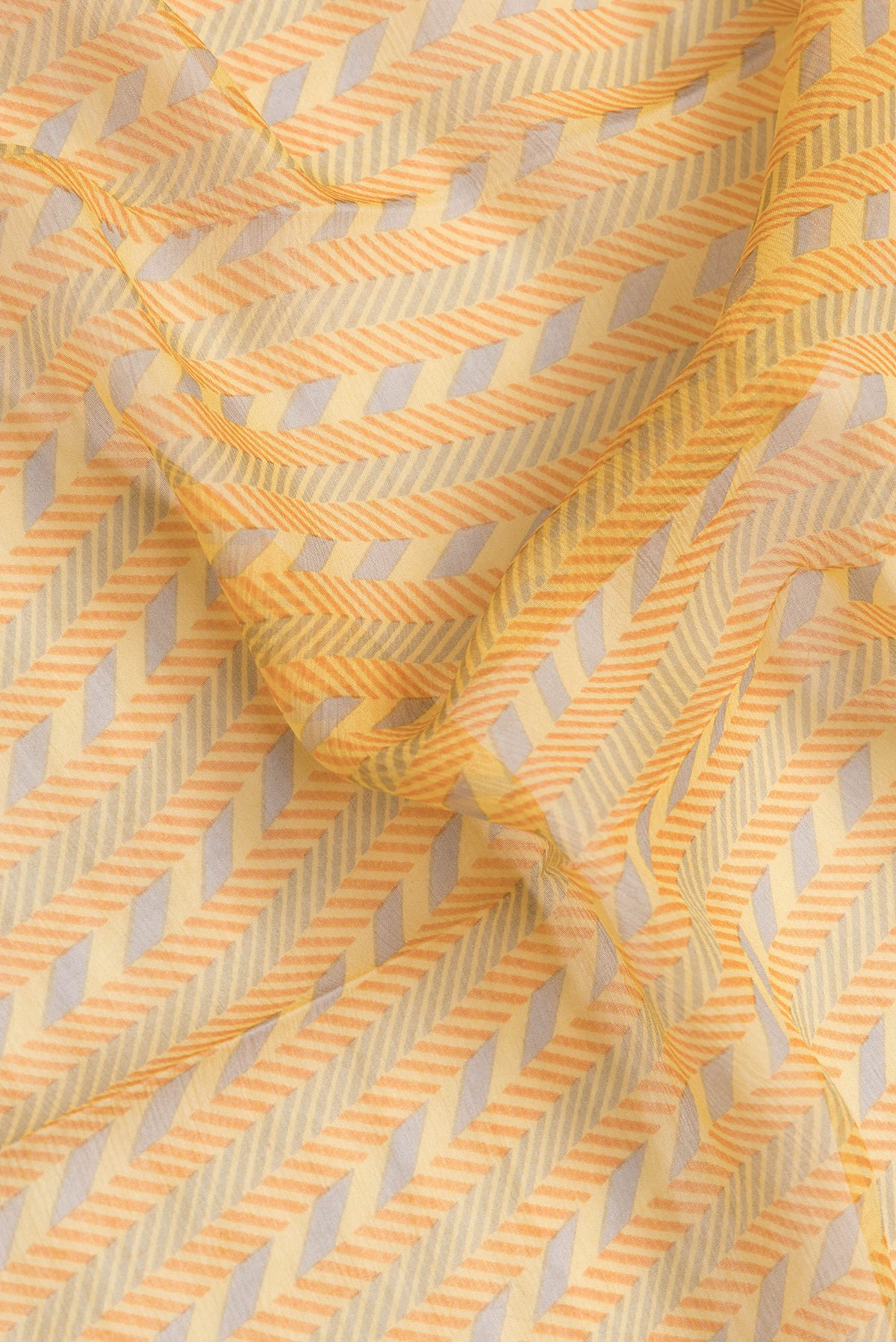 Close up of Yellow Dual Tone Mysore Georgette Saree with Printed design on the body and Zari Border.  displaying folds