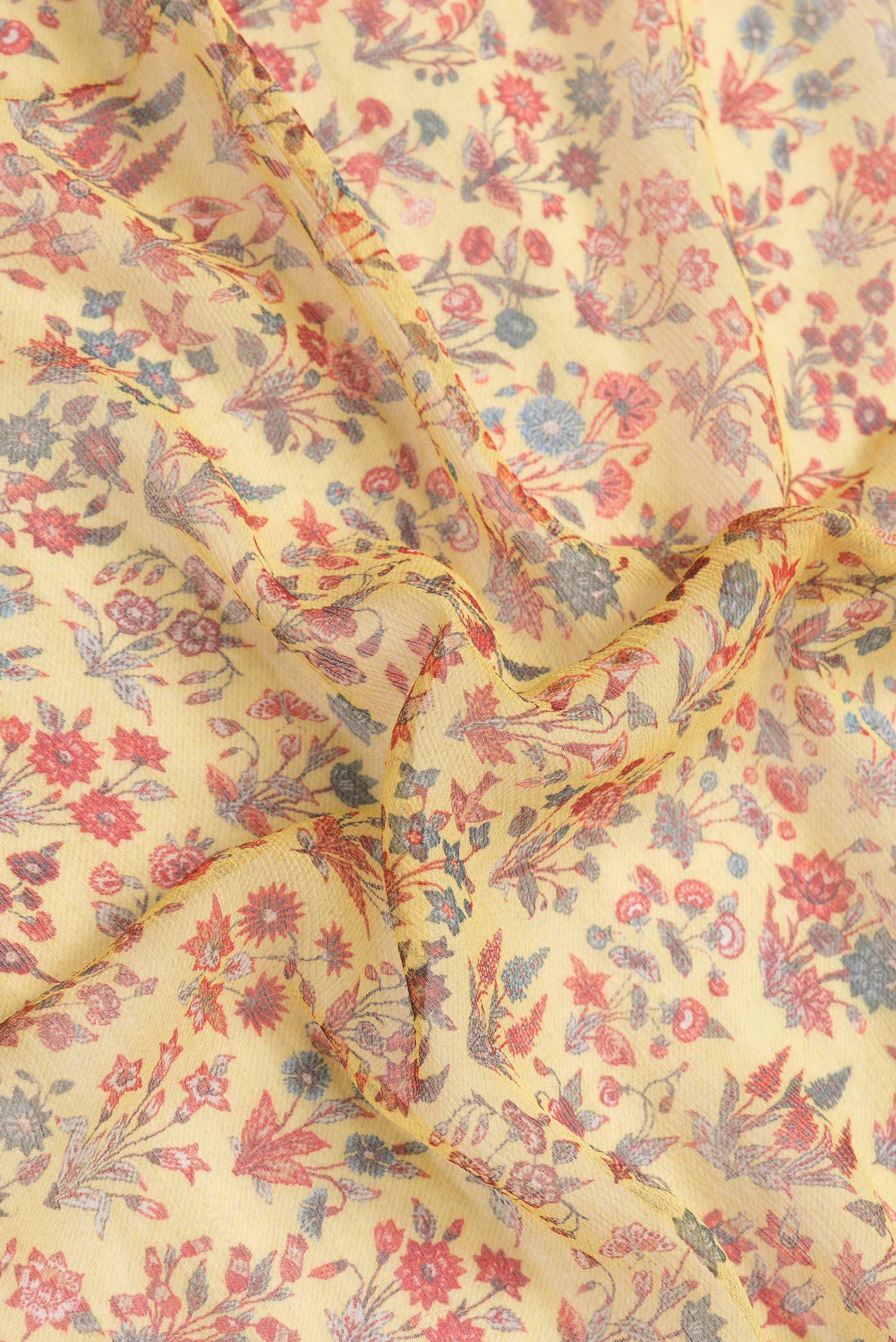 Close up of Yellow Dual Tone Mysore Chiffon Saree with Printed design on the body and Zari Border.  displaying folds