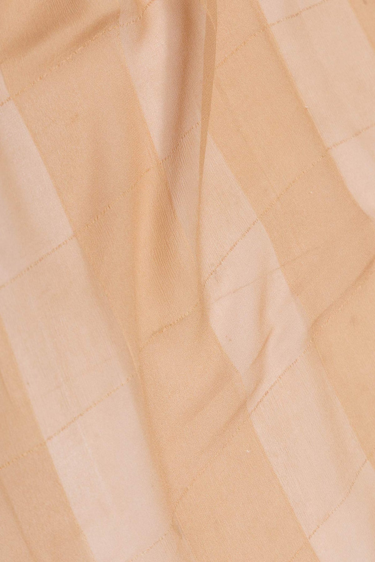 Close up of Peach Mysore Chiffon Saree with Checked design on the body and Embroidery Border displaying folds