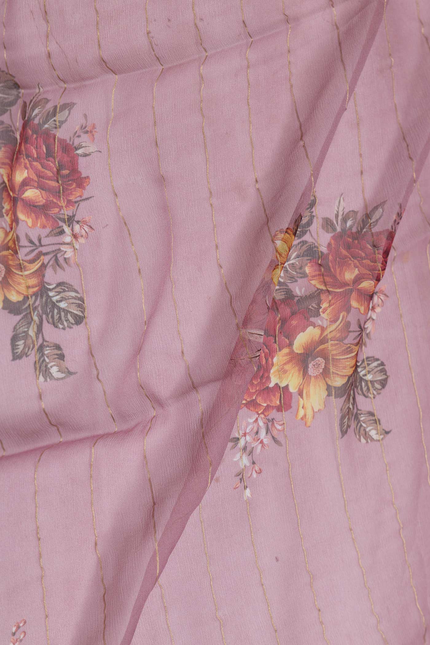 Close up of Pink Dual Tone Mysore Chiffon Saree with Printed design on the body and Zari Border displaying folds