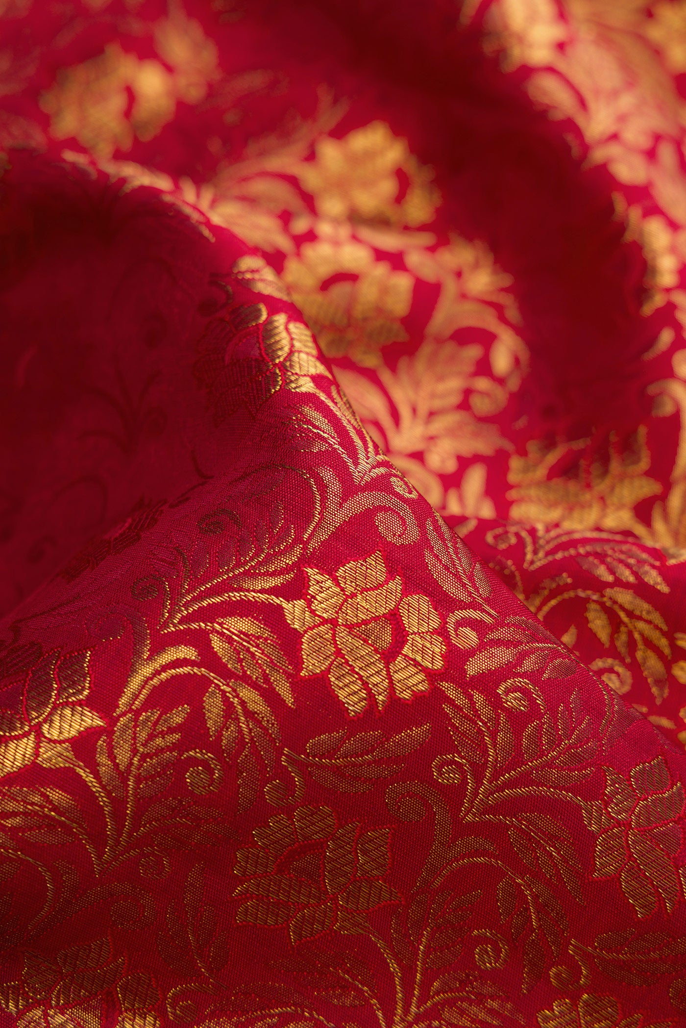 Close up of Pure Silk Pure Zari Maroon Kanjivaram Saree with Jacquard design on the body and Zari Border.  displaying folds