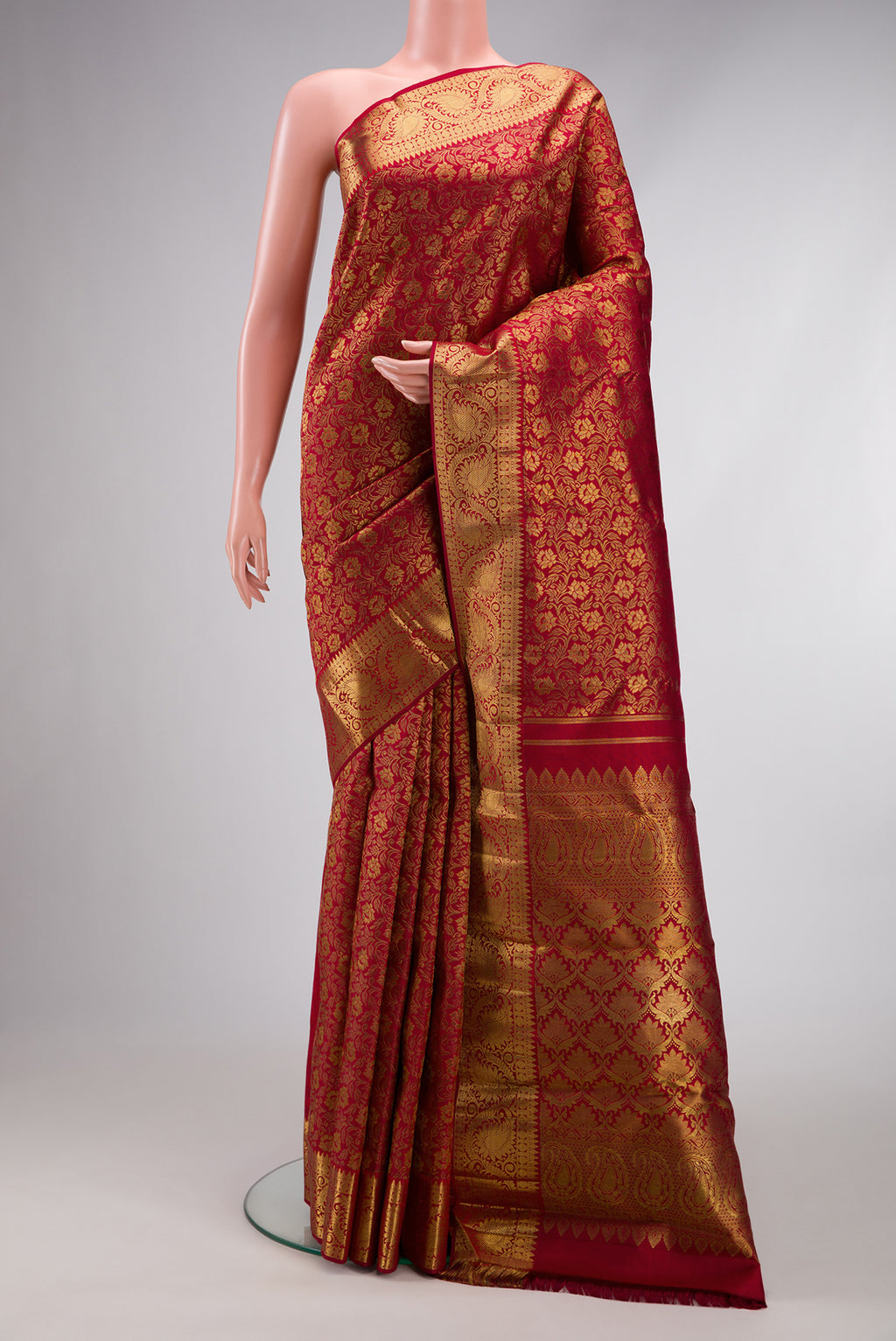 Pure Silk Pure Zari Maroon Kanjivaram Saree with Jacquard design on the body and Zari Border.  displayed on a mannequin