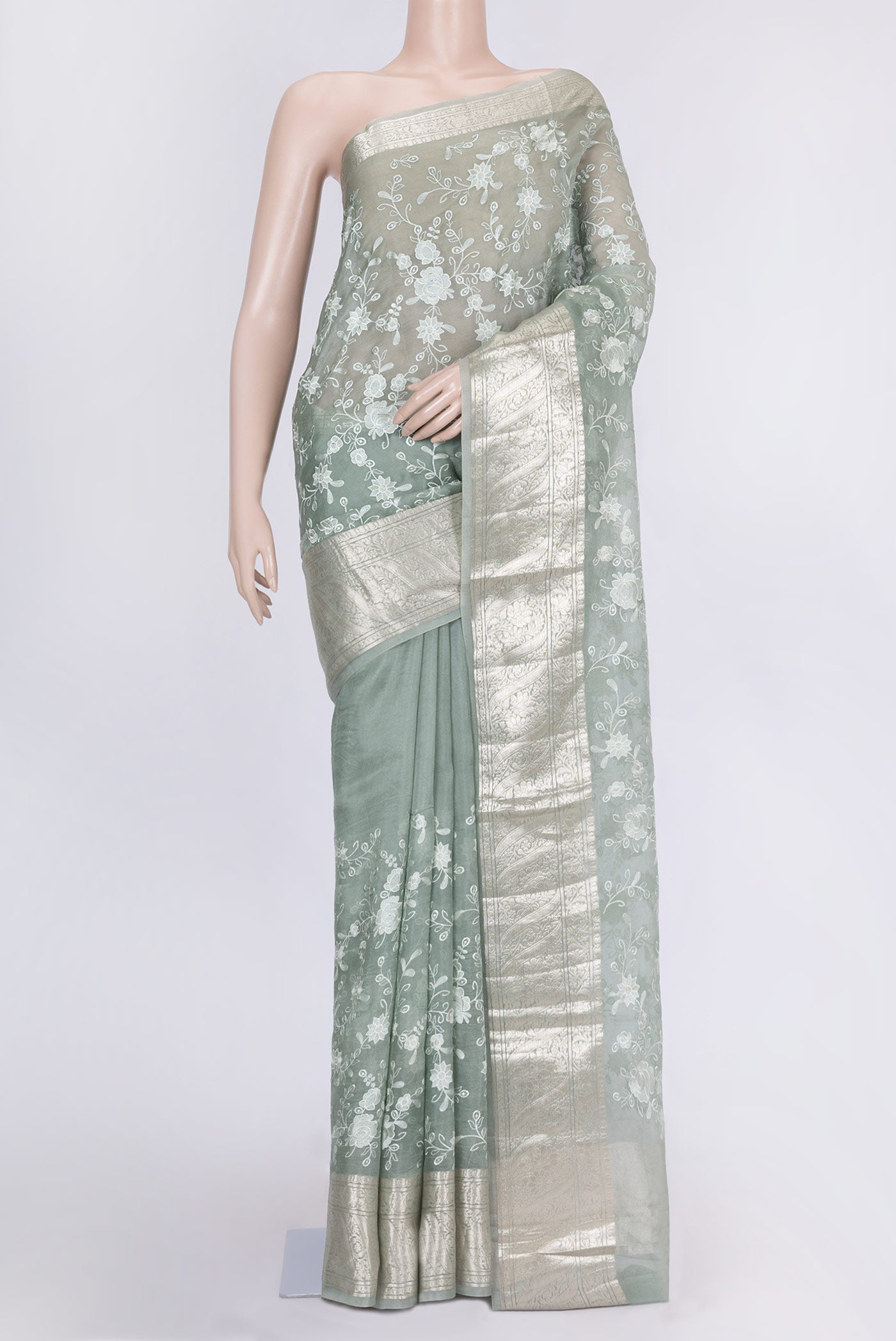 Light Green Dual Tone Organza Silk Saree with Zari Brocade on the body and Zari Border.  displayed on a mannequin