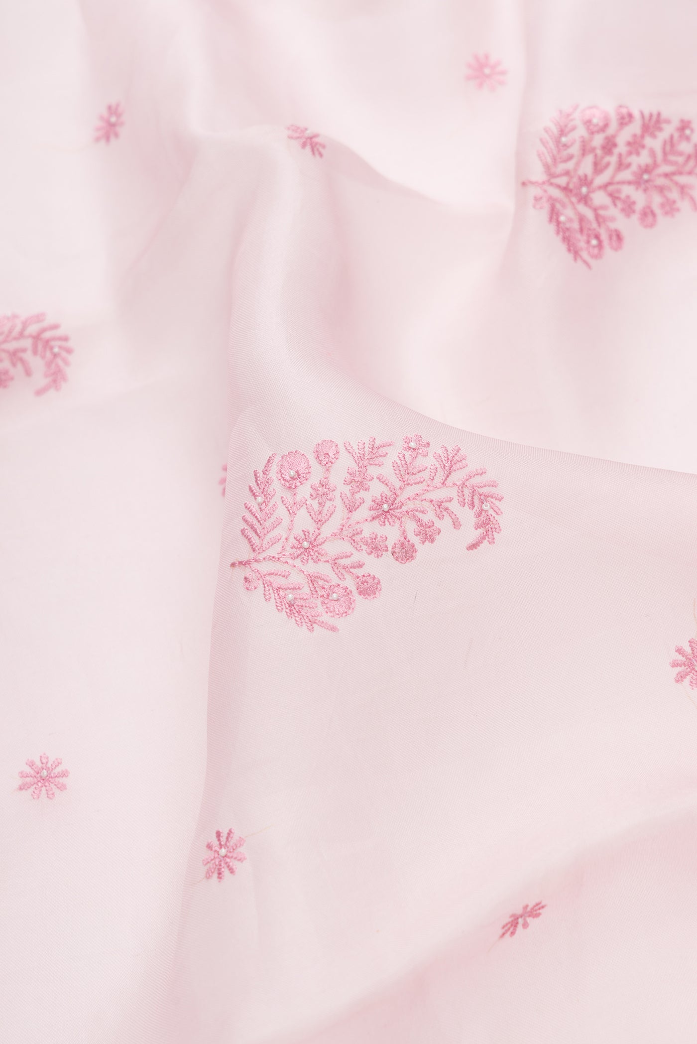 Close up of Pink Dual Tone Organza Silk Saree with Embroidery on the body and Embroidery Border.  displaying folds