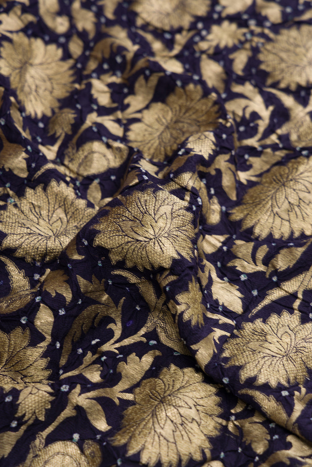 Close up of Navy Blue Dual Tone Bandhani Silk Saree with Bandhani Print on the body and Without Border.  displaying folds