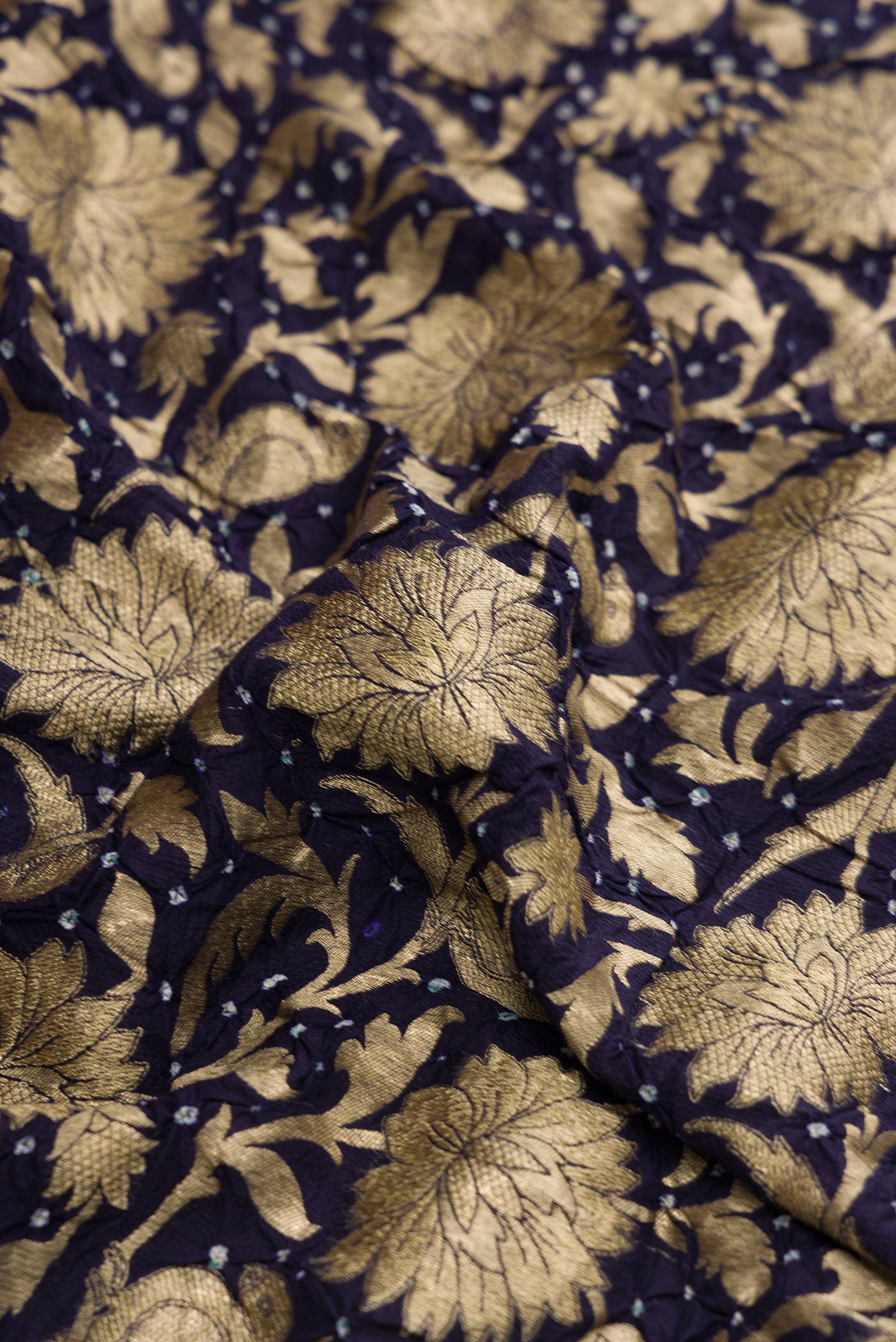 Close up of Navy Blue Dual Tone Bandhani Silk Saree with Bandhani Print on the body and Without Border.  displaying folds