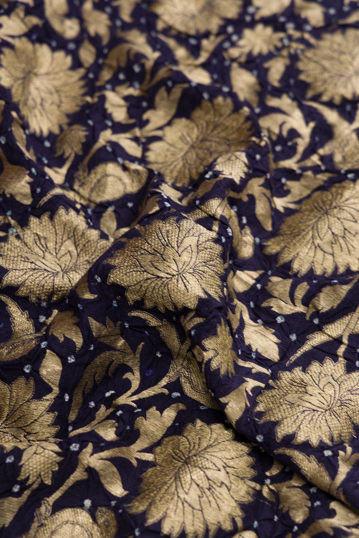 Close up of Navy Blue Dual Tone Bandhani Silk Saree with Bandhani Print on the body and Without Border.  displaying folds