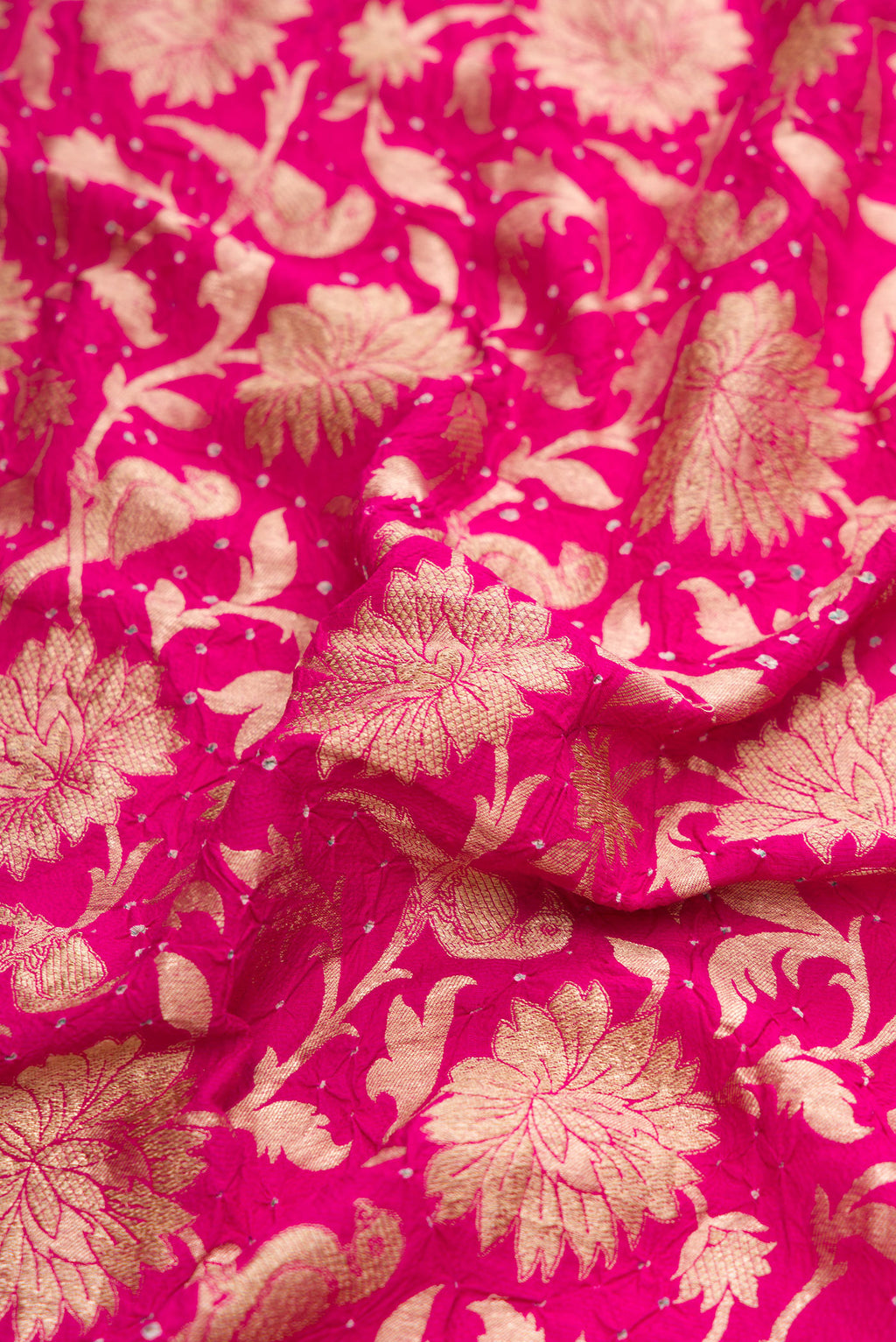 Close up of Dark Pink Dual Tone Bandhani Silk Saree with Bandhani Print on the body and Without Border.  displaying folds