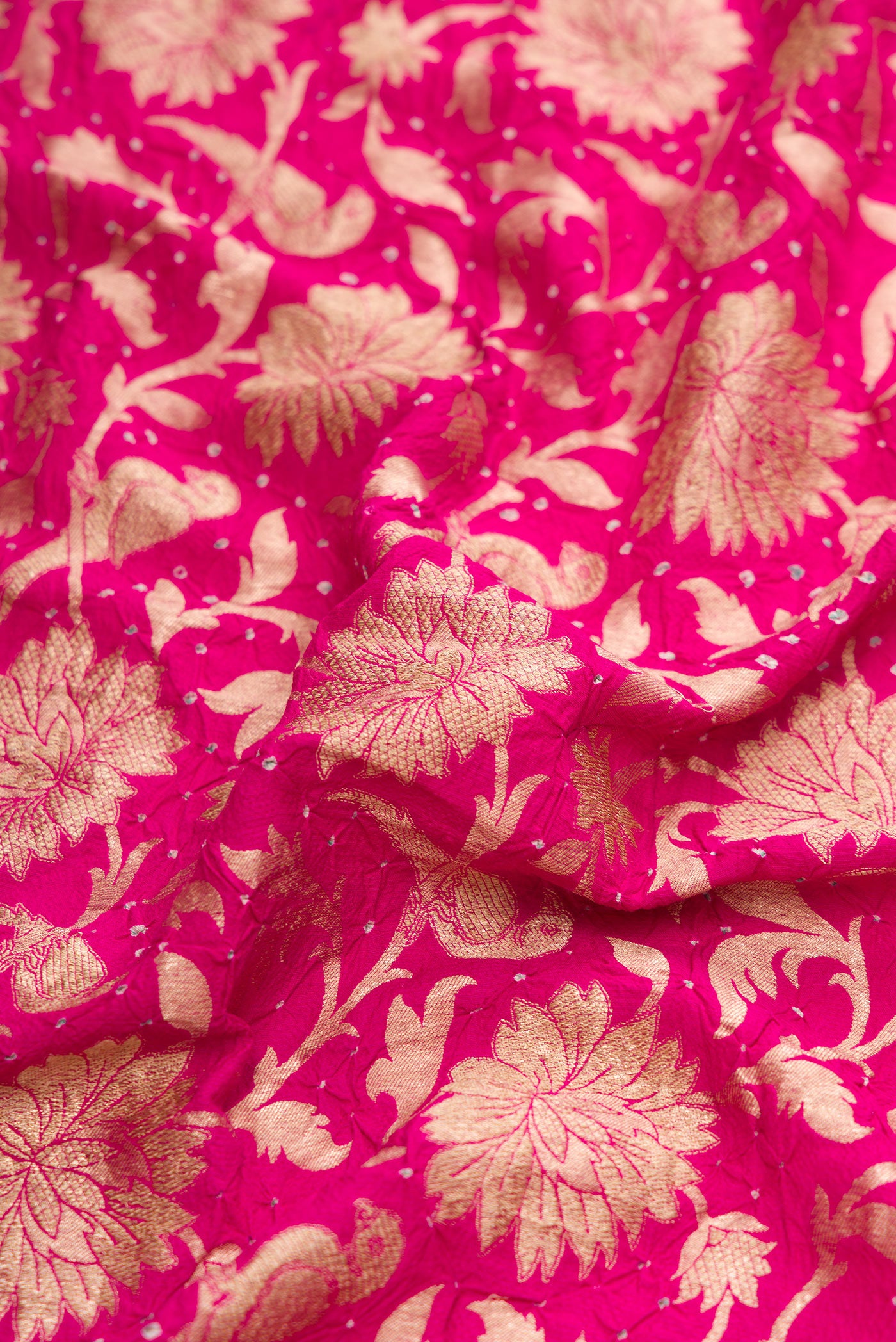 Close up of Dark Pink Dual Tone Bandhani Silk Saree with Bandhani Print on the body and Without Border.  displaying folds