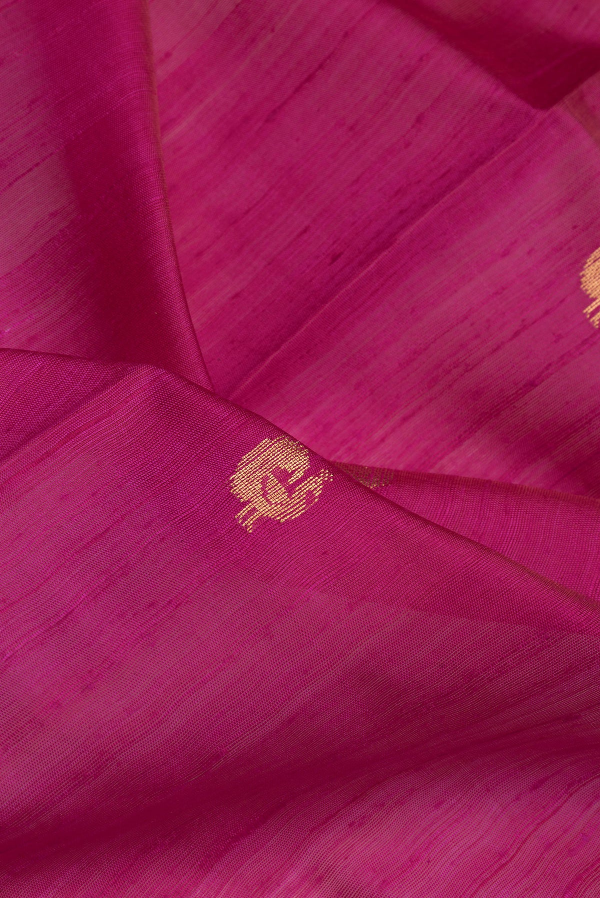 Close up of Pink Dual Tone Tussar Silk Saree with Zari Butta on the body and Fancy Border.  displaying folds